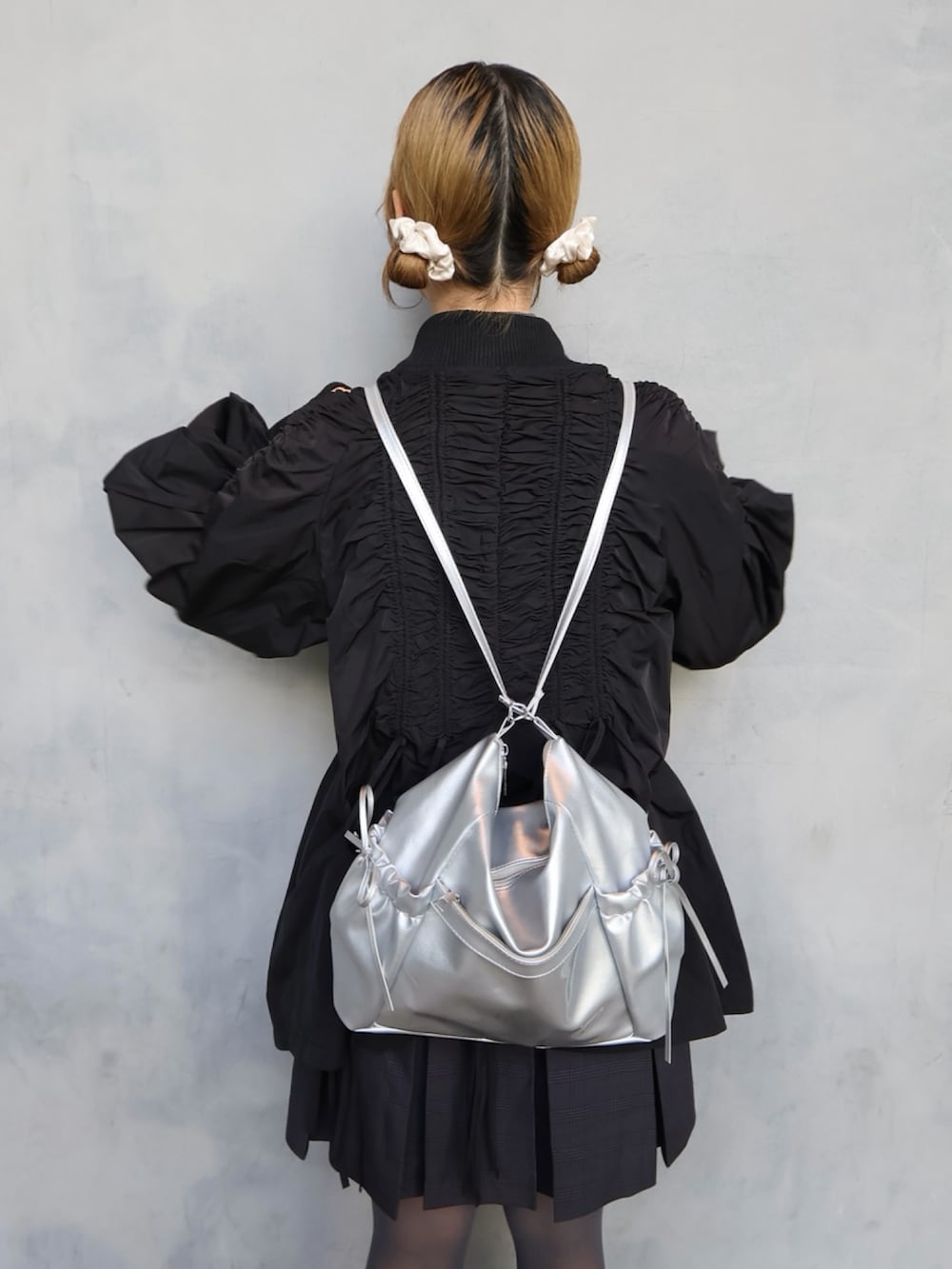 ブラック系のスニーカー、グレー系のスカート、グレー系のシャツ/ブラウスを着用したレディースの春コーディネートの2枚目の写真