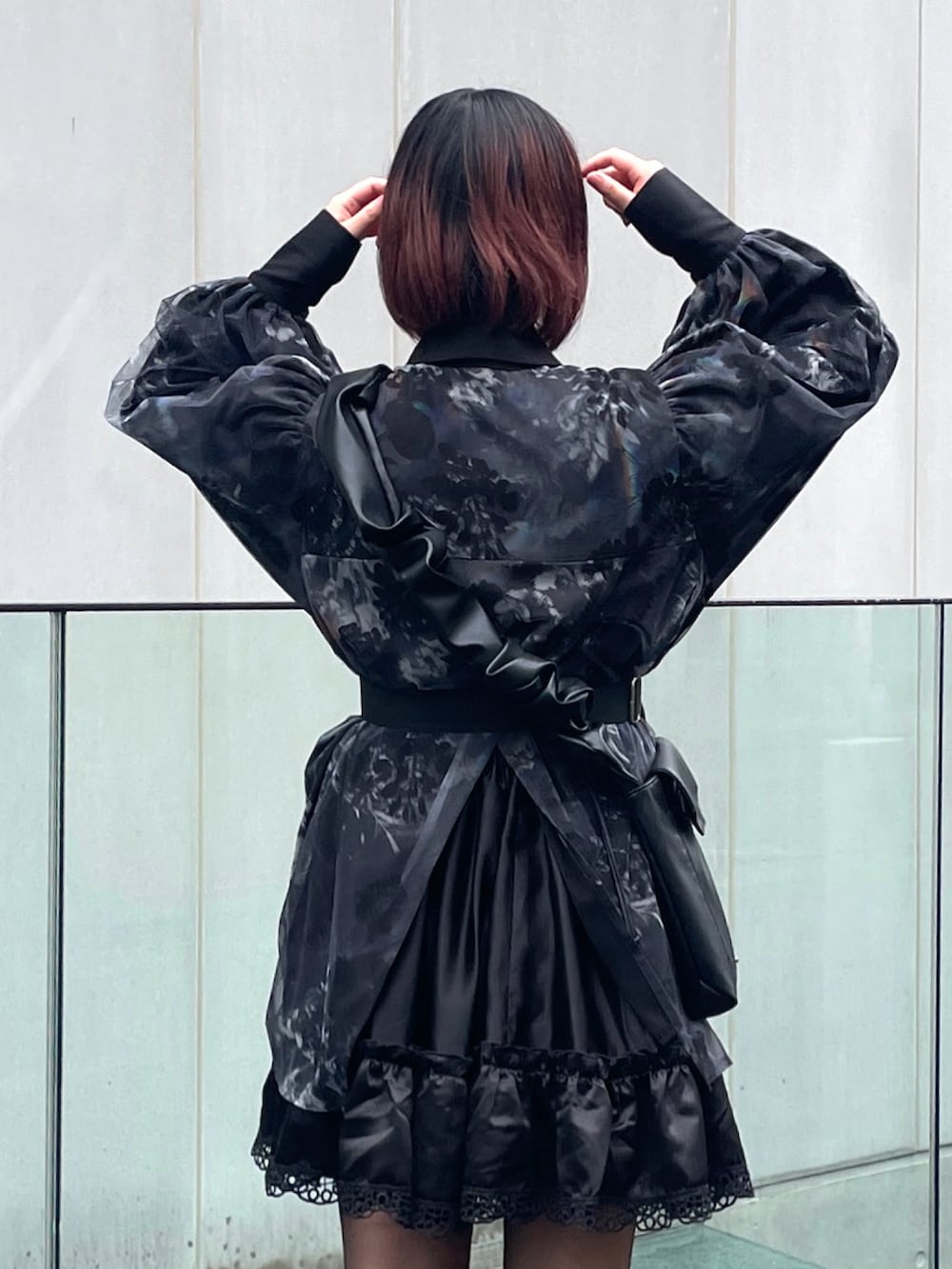 ブラック系のスニーカー、グレー系のシャツ/ブラウス、ブラック系のショルダーバッグを着用したレディースの春コーディネートの4枚目の写真