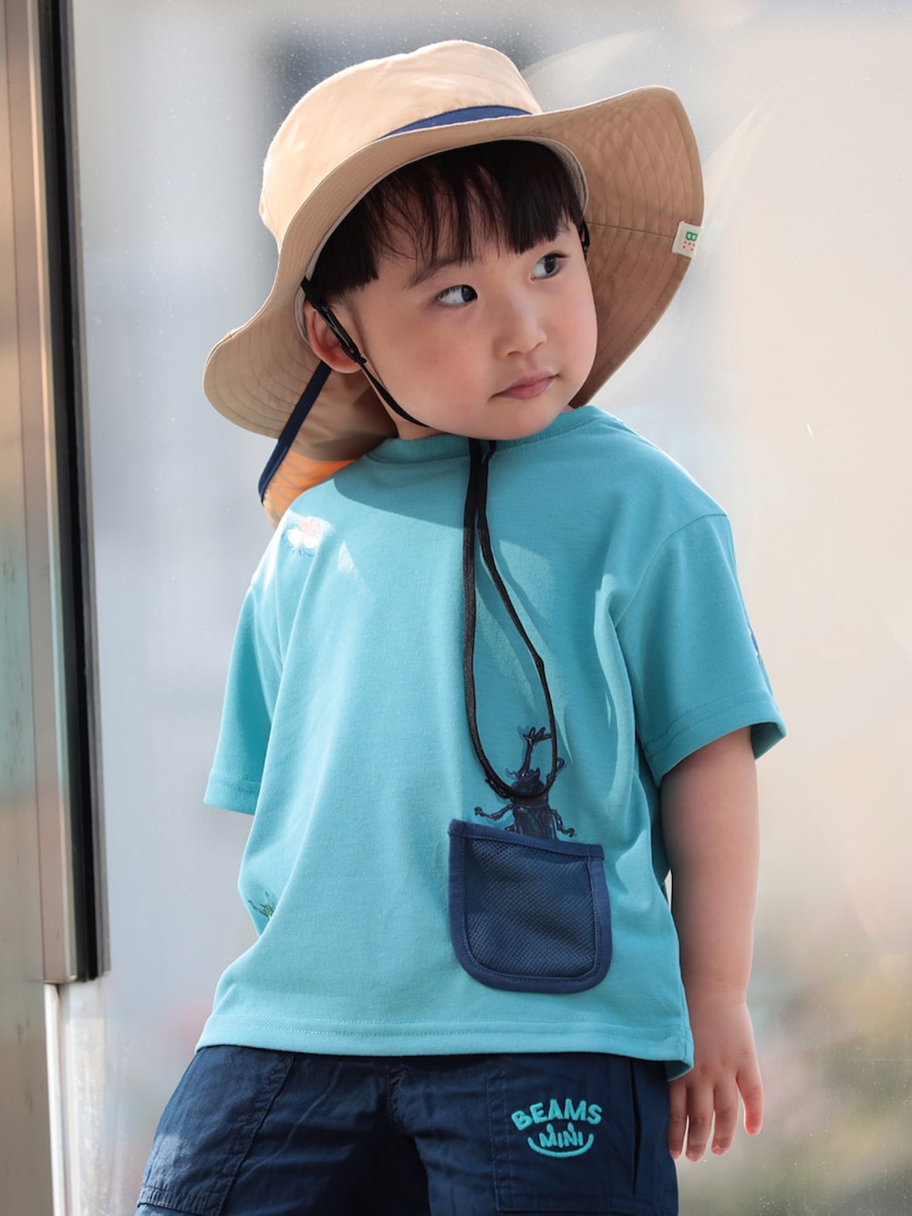 ブルー系のその他パンツ、ブルー系のTシャツ/カットソー、ベージュ系のハットを着用したキッズの春コーディネートの2枚目の写真