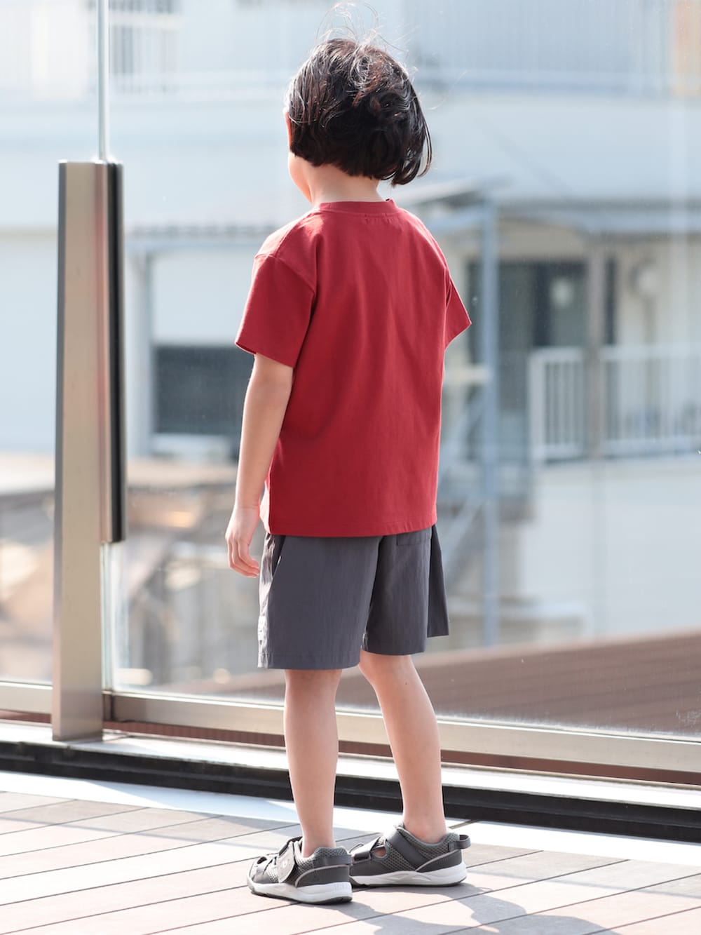 レッド系のTシャツ/カットソー、グレー系のその他パンツ、ベージュ系のキャップを着用したキッズの夏コーディネートの3枚目の写真