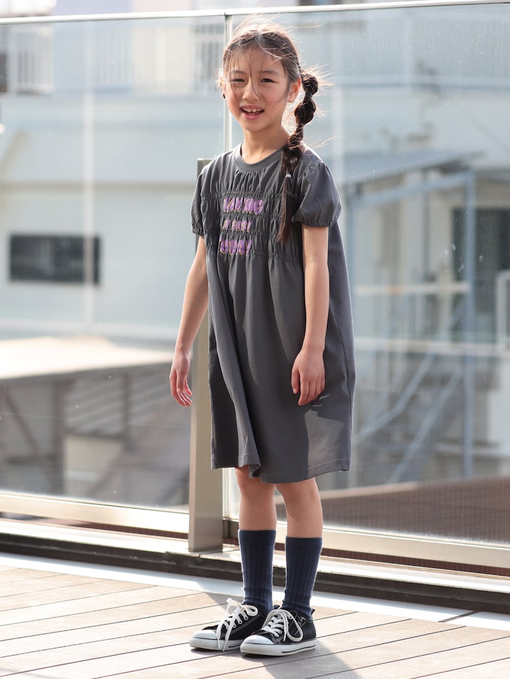 グレー系のワンピースを着用したキッズの春コーディネートの2枚目の写真
