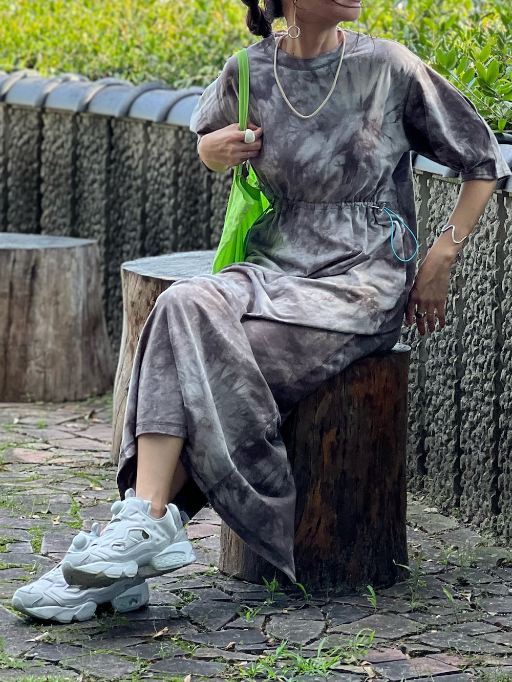 ブラウン系のワンピース、グレー系のスニーカー、グリーン系のトートバッグを着用したレディースの秋コーディネートの5枚目の写真