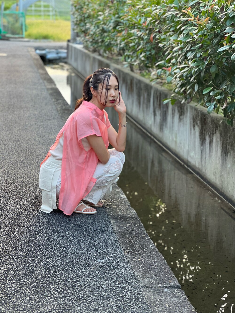 ピンク系のシャツ/ブラウス、ホワイト系のその他パンツ、ホワイト系のショルダーバッグを着用したレディースの夏コーディネートの2枚目の写真