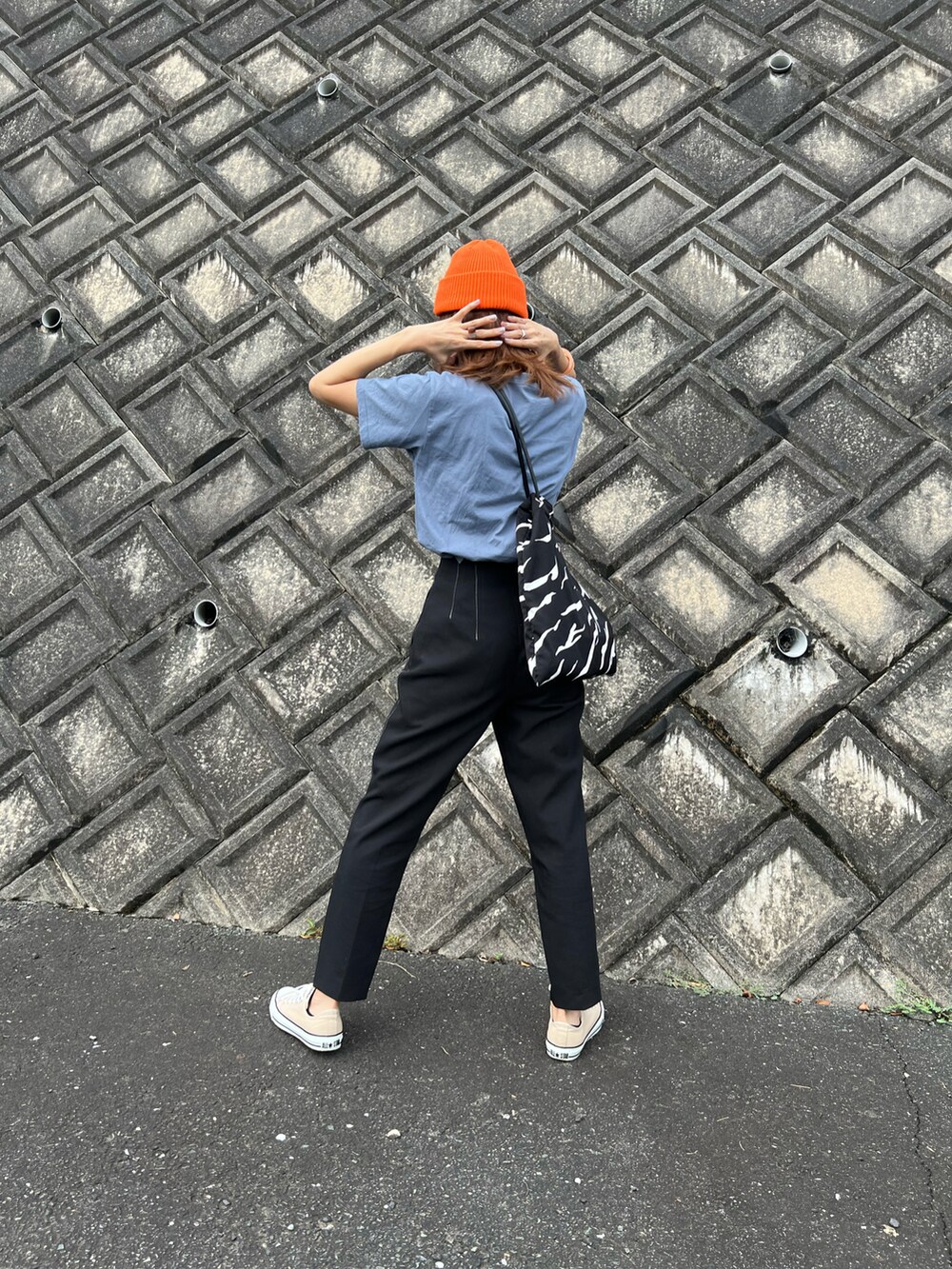 ブルー系のTシャツ/カットソー、ブラック系のパンツ、ベージュ系のスニーカーを着用したレディースの秋コーディネートの3枚目の写真
