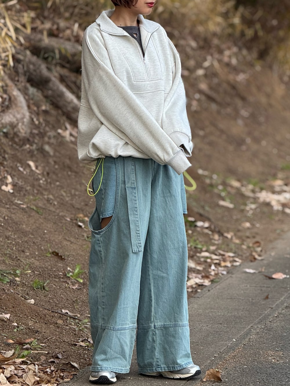 ベージュ系のスウェット、グレー系のTシャツ/カットソー、ブルー系のデニムパンツを着用したレディースの冬コーディネートの4枚目の写真