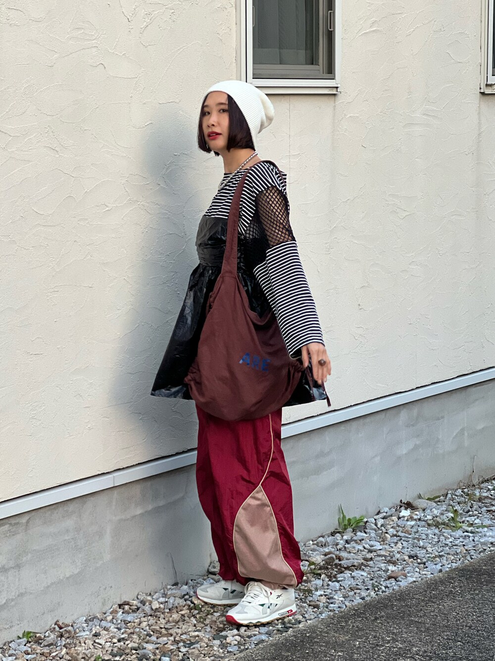 ブラック系のキャミソール、ブラック系のTシャツ/カットソー、レッド系のその他パンツを着用したレディースの秋コーディネートの4枚目の写真