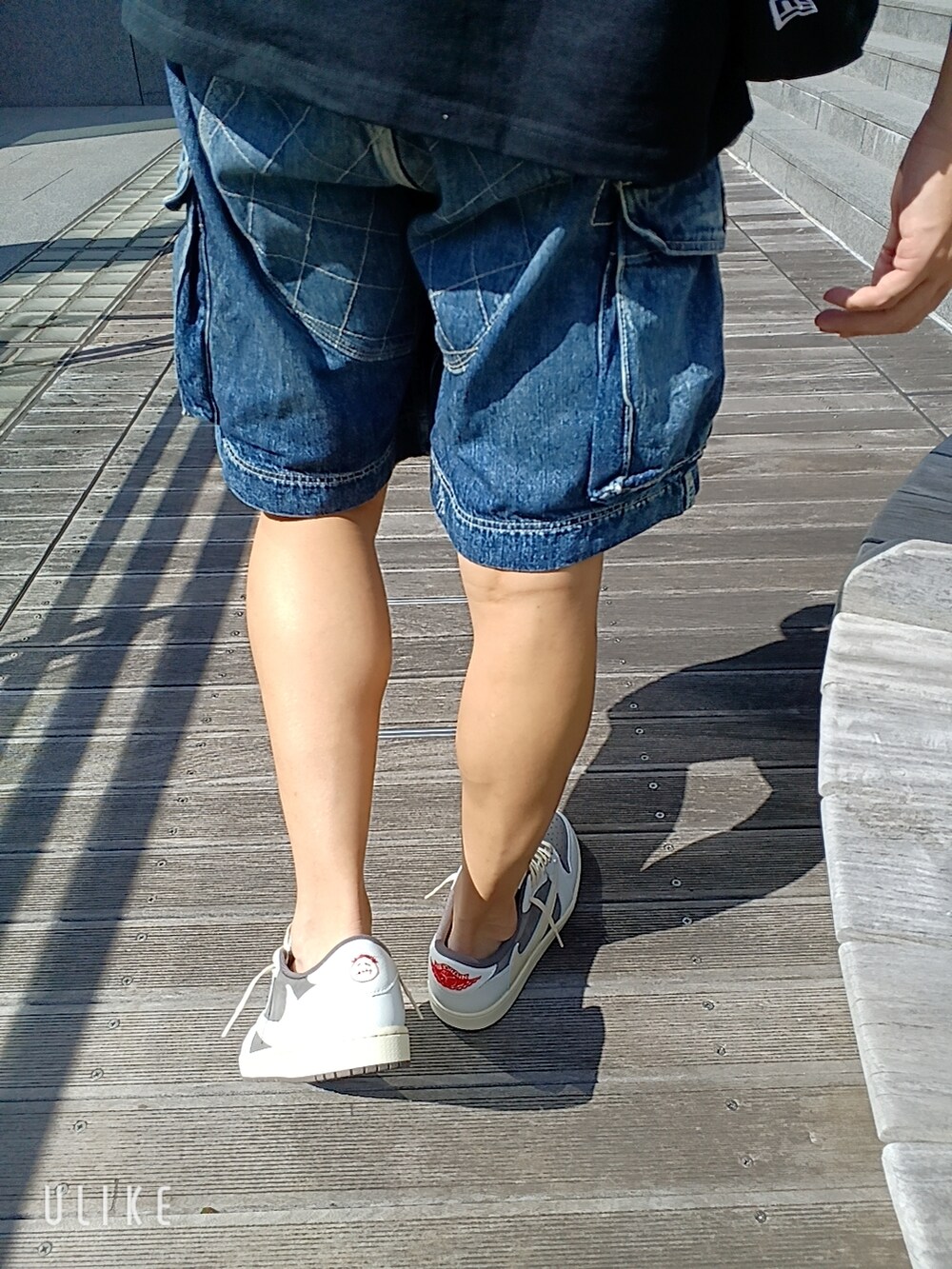 ブラウン系のスニーカー、ブルー系のデニムパンツ、ブラック系のTシャツ/カットソーを着用したメンズの秋コーディネートの5枚目の写真