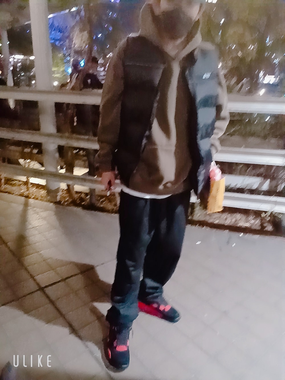 レッド系のスニーカー、ブラック系のその他パンツ、ブラウン系のパーカーを着用したメンズの秋コーディネートの3枚目の写真