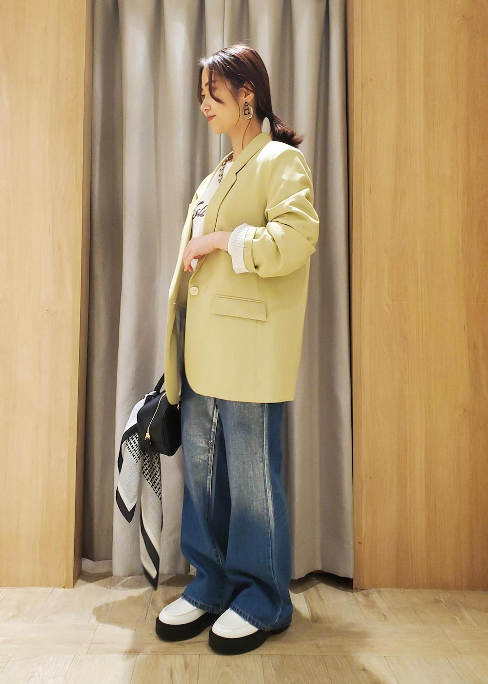 ホワイト系のローファー、ホワイト系のスウェット、ブルー系のデニムパンツを着用したレディースの冬コーディネートの2枚目の写真