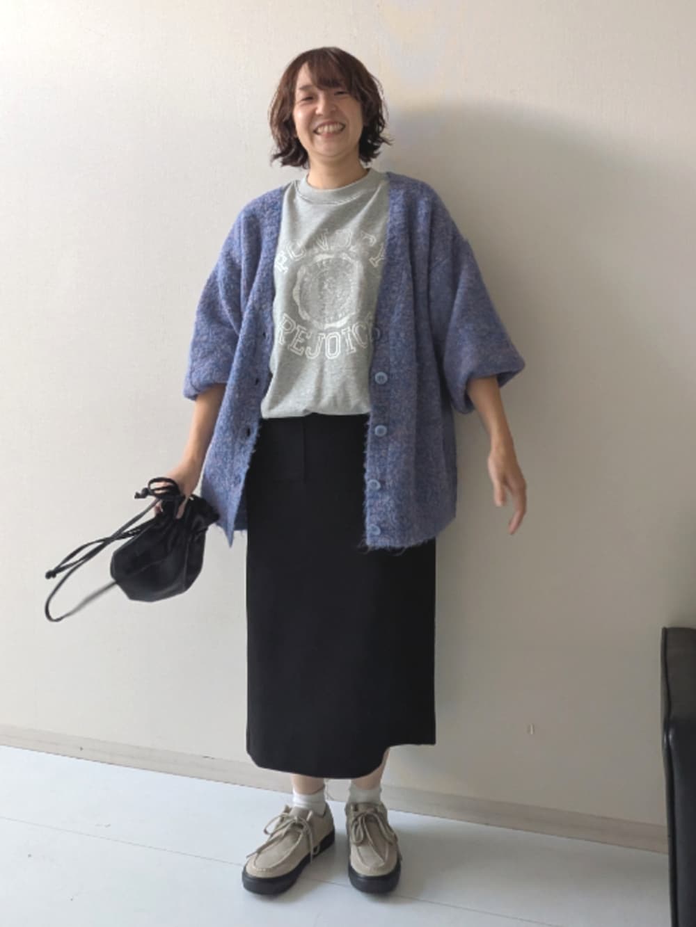 ブラウン系のスニーカー、ブラック系のニット/セーター、ブラック系のベストを着用したレディースの秋コーディネートの7枚目の写真