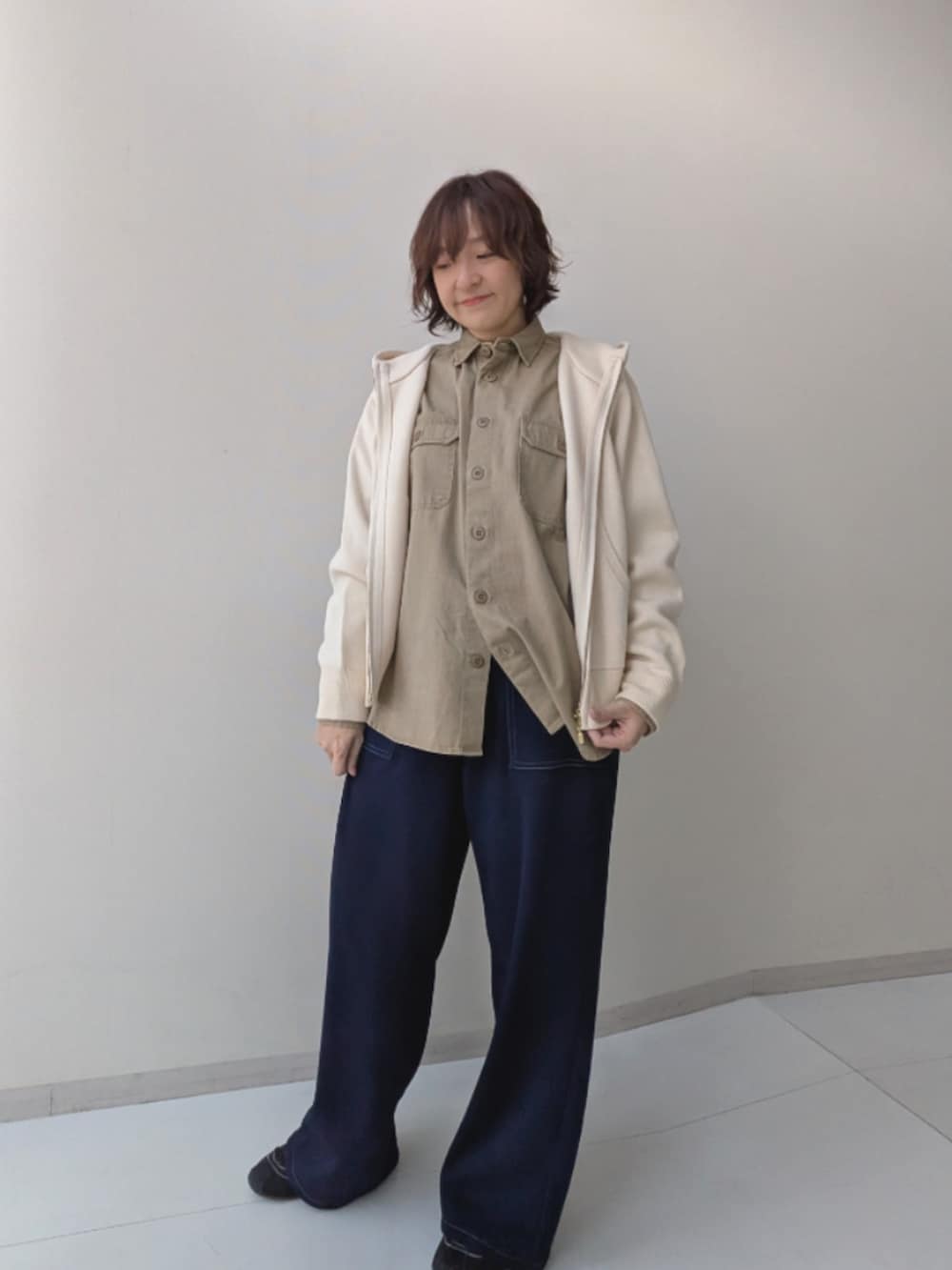 ベージュ系のシャツ/ブラウス、ブラウン系のカバーオール、ブルー系のデニムパンツを着用したレディースの秋コーディネートの4枚目の写真