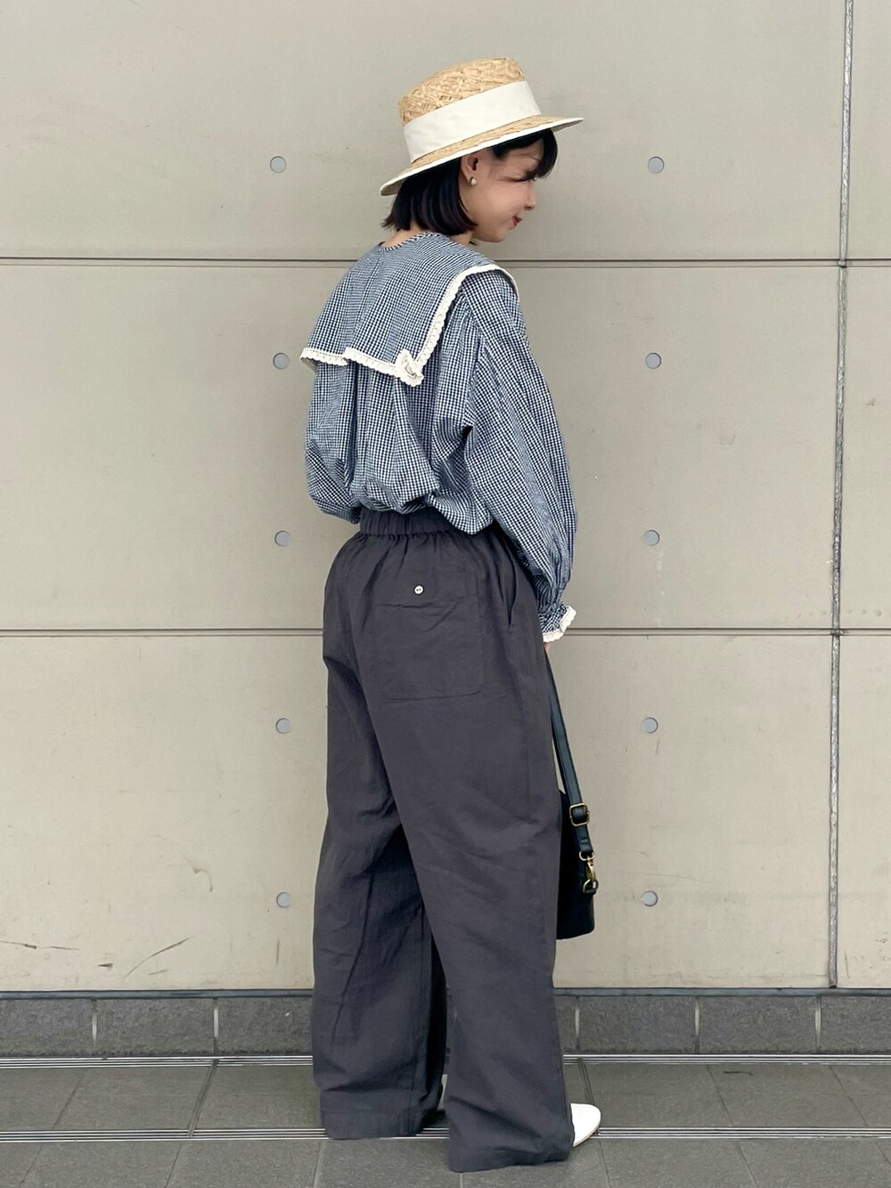 ホワイト系のその他シューズ、ブラック系のハンドバッグ、ブルー系のシャツ/ブラウスを着用したレディースの春コーディネートの2枚目の写真