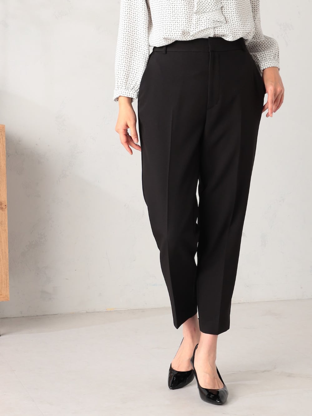 ベージュ系のステンカラーコート、ホワイト系のシャツ/ブラウス、ブラック系のその他パンツを着用したレディースの冬コーディネートの5枚目の写真