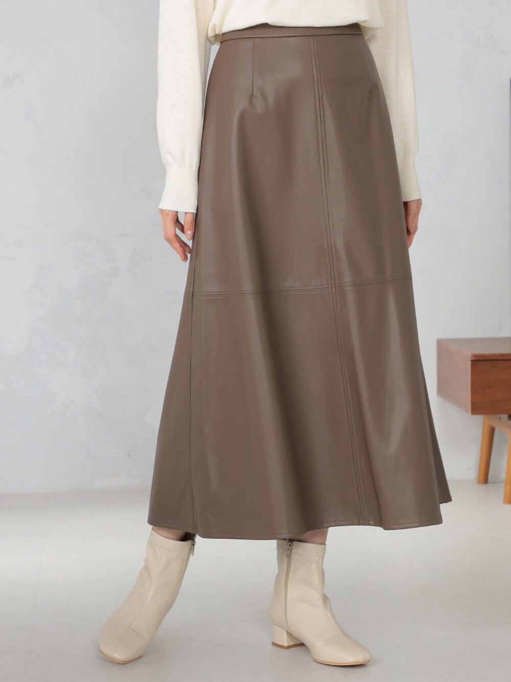 ホワイト系のニット/セーター、ブラウン系のカーディガン/ボレロ、ブラウン系のスカートを着用したレディースの秋コーディネートの3枚目の写真