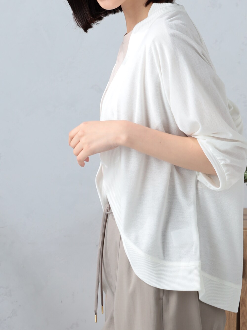 ピンク系のTシャツ/カットソー、ベージュ系のその他パンツ、ホワイト系のカーディガン/ボレロを着用したレディースの夏コーディネートの3枚目の写真