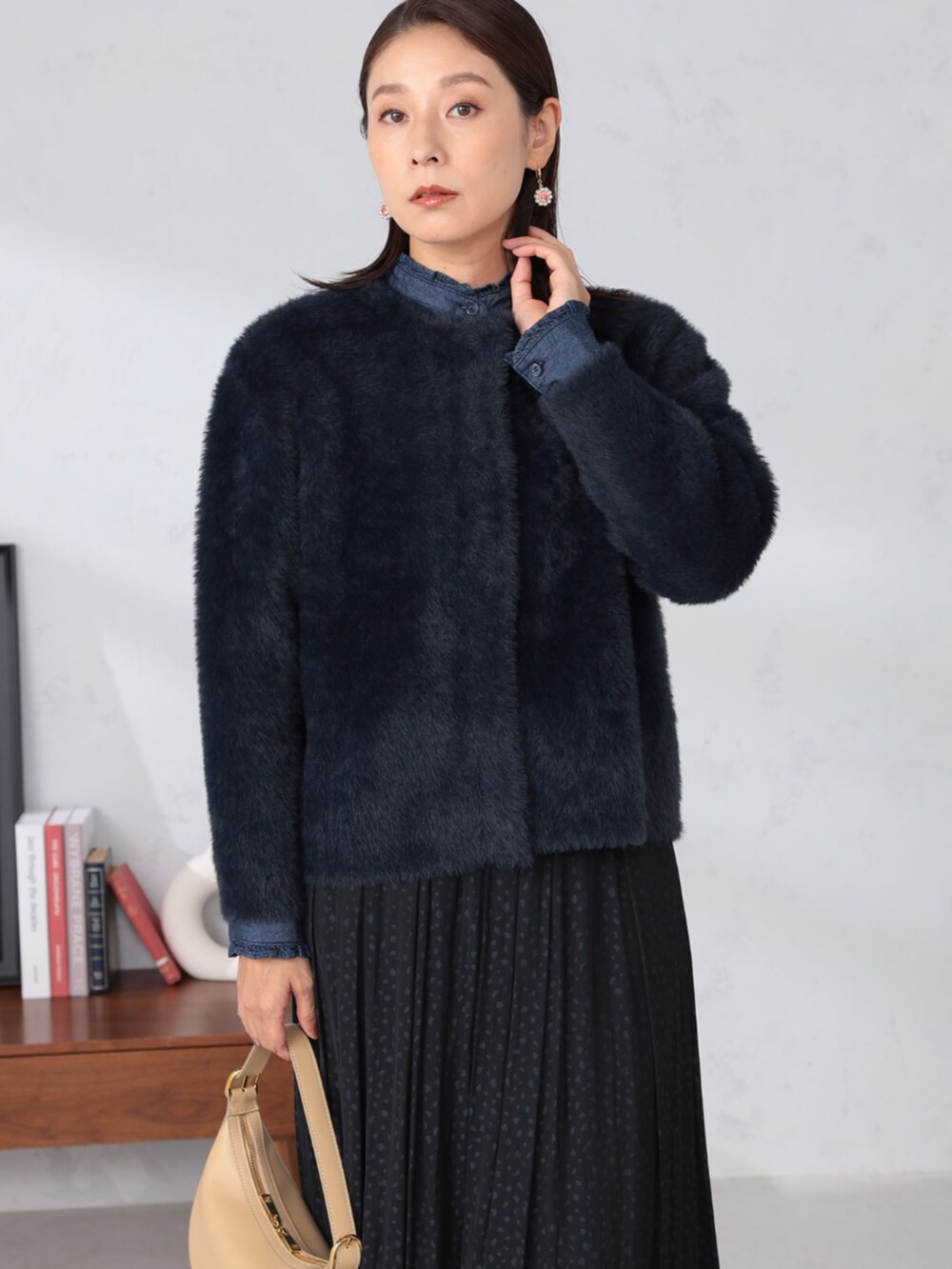 ブルー系のシャツ/ブラウス、ブルー系のカーディガン/ボレロ、ブラック系のスカートを着用したレディースの秋コーディネートの2枚目の写真