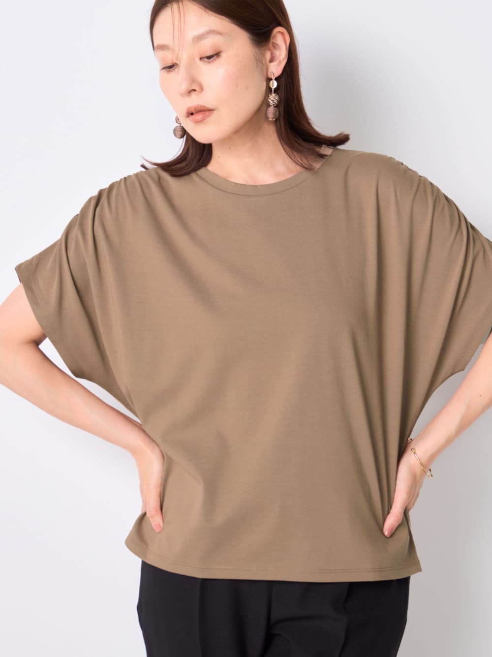 ベージュ系のTシャツ/カットソーを着用したレディースの秋コーディネートの2枚目の写真