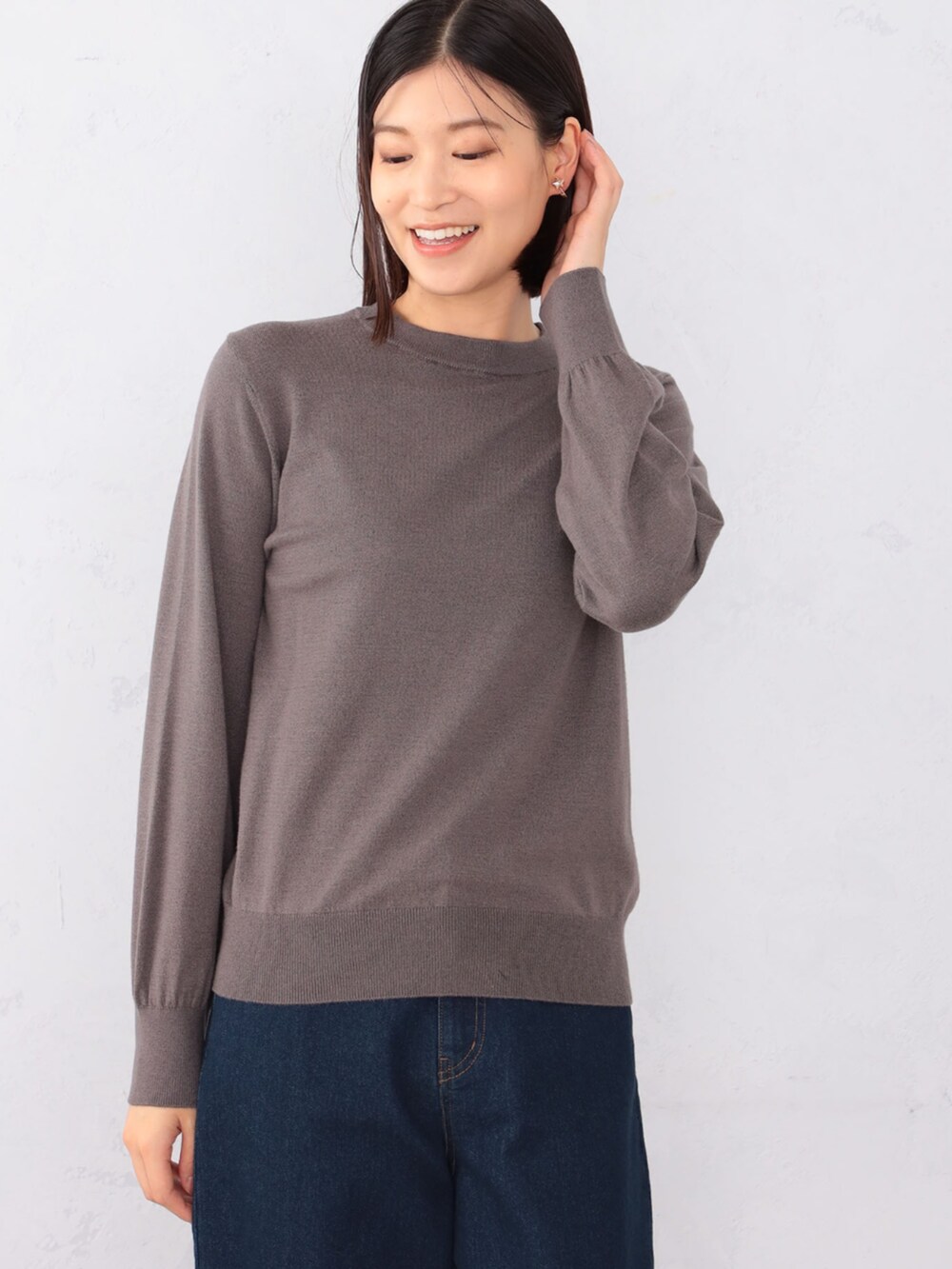 ブルー系のデニムパンツ、ブラウン系のアンサンブルを着用したレディースの秋コーディネートの3枚目の写真