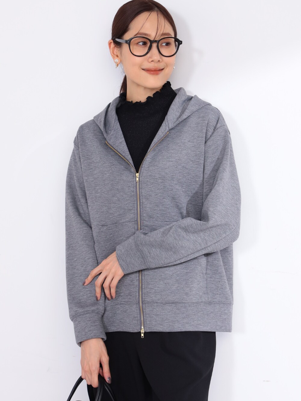 ブラック系のTシャツ/カットソー、グレー系のパーカー、ブラック系のその他パンツを着用したレディースの冬コーディネートの2枚目の写真