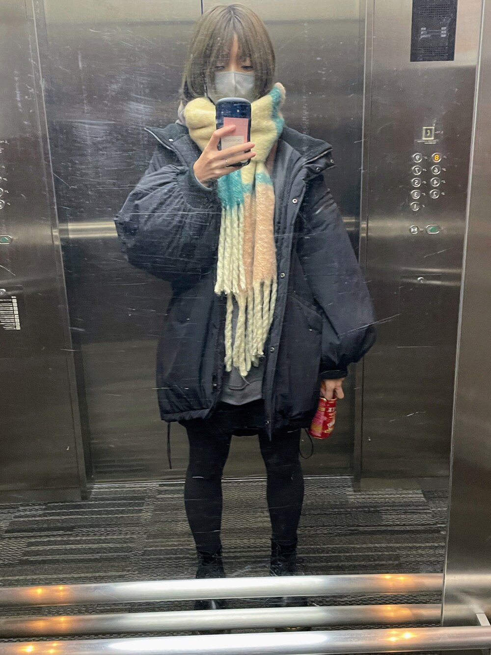 グレー系のパーカー、ブラック系のその他パンツ、ブラック系のブーツを着用したレディースの冬コーディネートの2枚目の写真