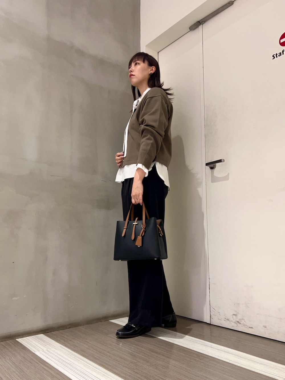 ホワイト系のシャツ/ブラウス、ブラック系のトートバッグ、ブラック系のその他パンツを着用したレディースの秋コーディネートの2枚目の写真