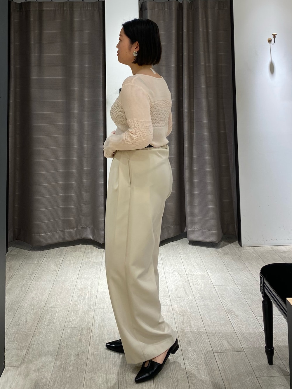 ピンク系のニット/セーター、ホワイト系のその他パンツ、ブラック系のパンプスを着用したレディースの春コーディネートの5枚目の写真