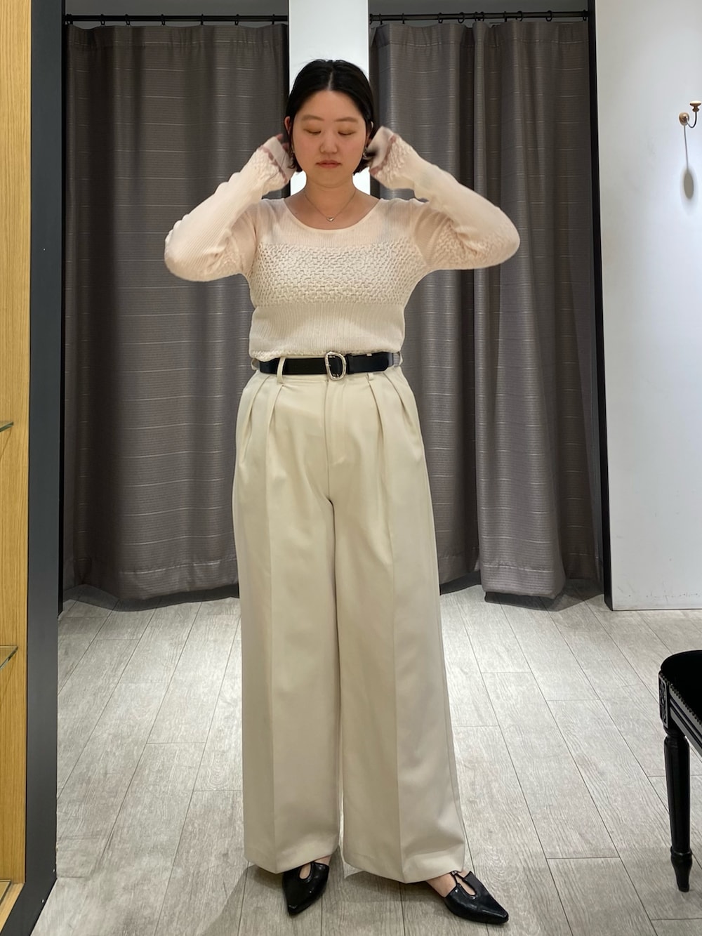 ピンク系のニット/セーター、ホワイト系のその他パンツ、ブラック系のパンプスを着用したレディースの春コーディネートの2枚目の写真