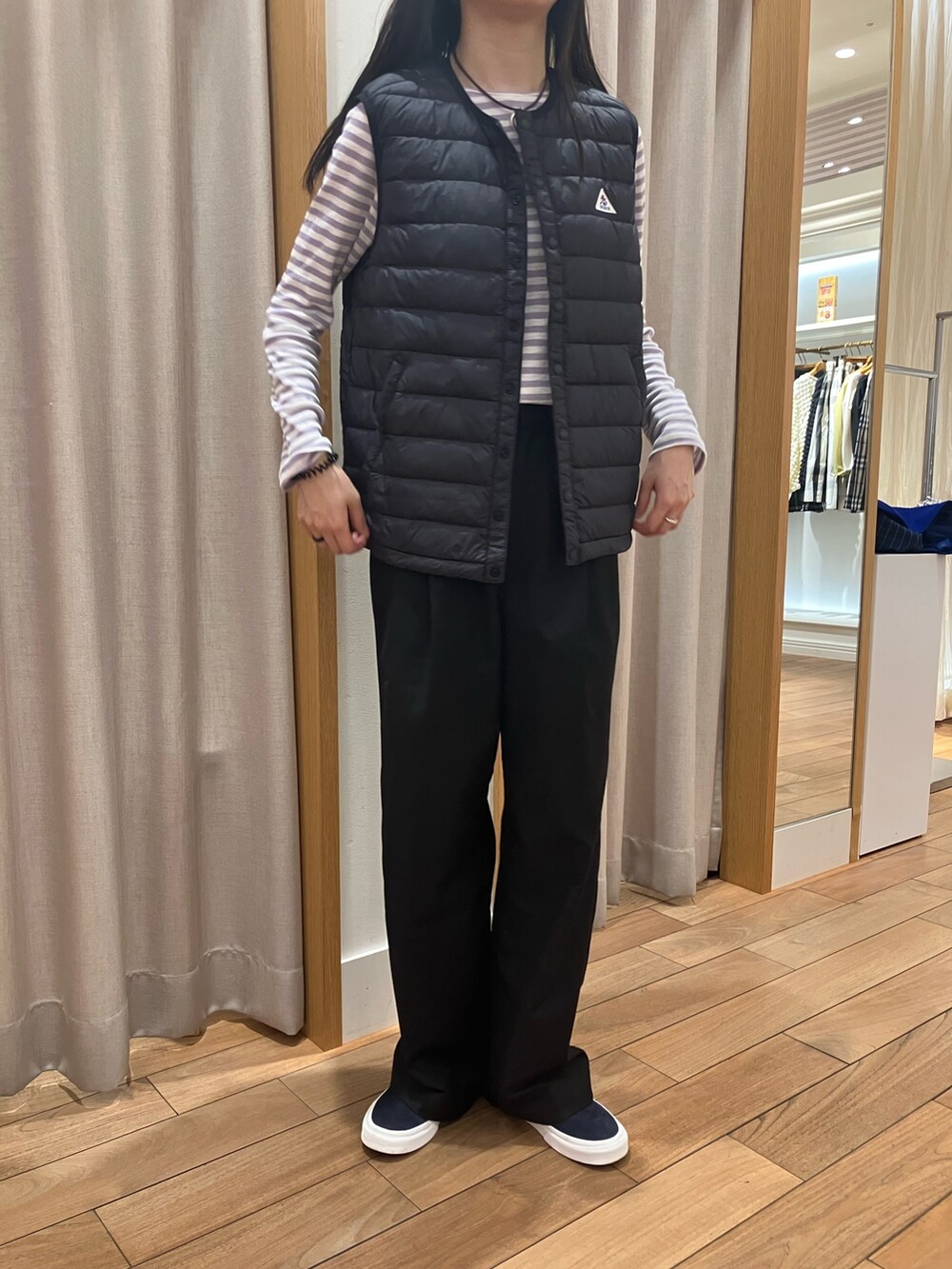 ブルー系のテーラードジャケット、ブラック系のダウンベスト、パープル系のTシャツ/カットソーを着用したレディースの夏コーディネートの8枚目の写真