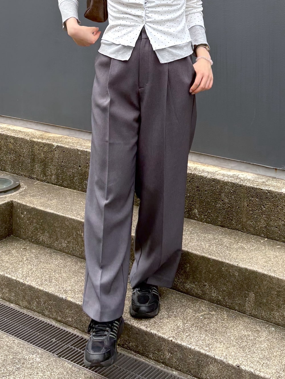 グレー系のスラックス、ホワイト系のTシャツ/カットソーを着用したレディースの夏コーディネートの5枚目の写真