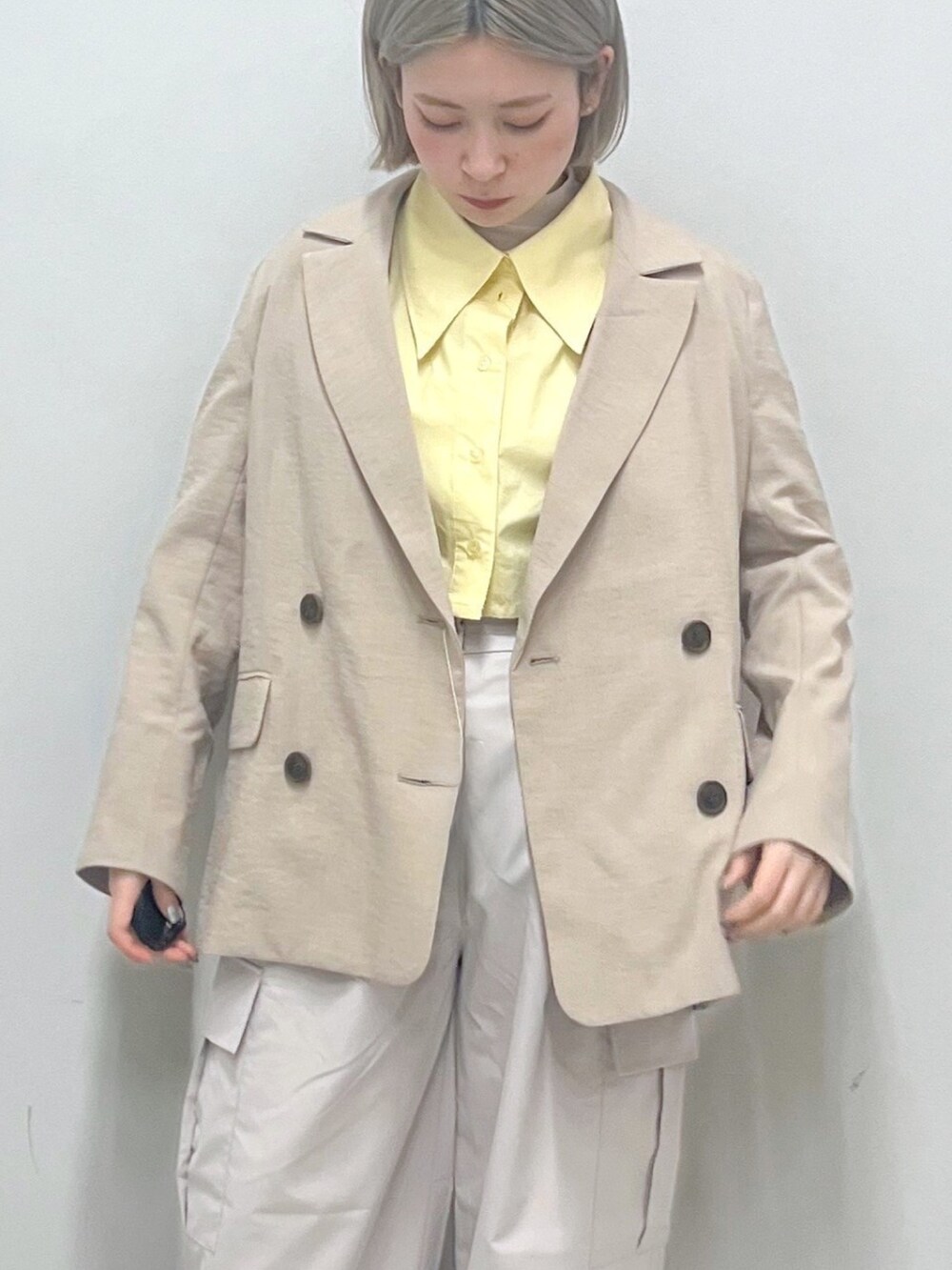 ベージュ系のカーゴパンツ、ベージュ系のテーラードジャケット、イエロー系のシャツ/ブラウスを着用したレディースの春コーディネートの4枚目の写真