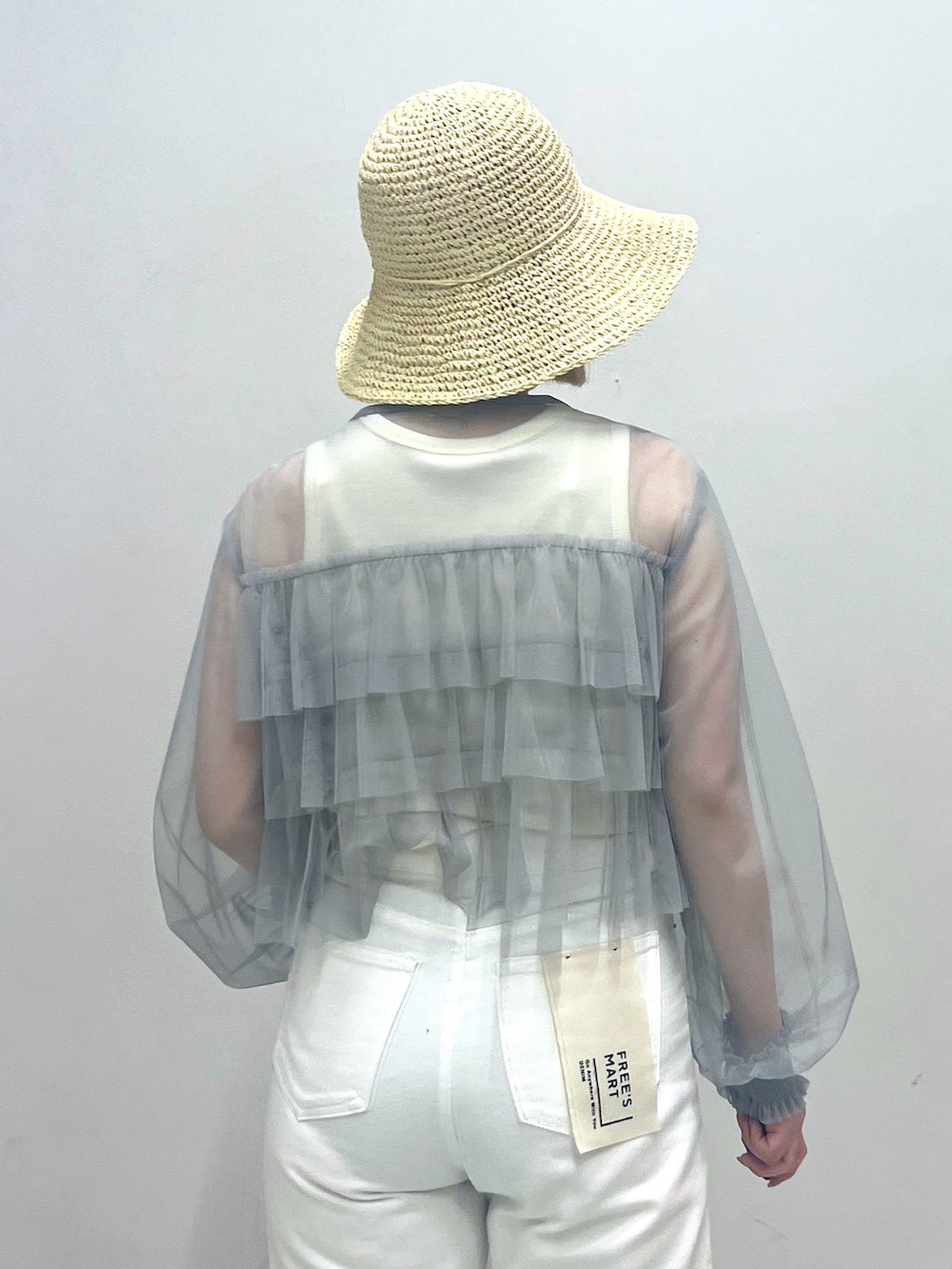 シルバー系のパンプス、ホワイト系のデニムパンツ、ホワイト系のタンクトップを着用したレディースの夏コーディネートの6枚目の写真