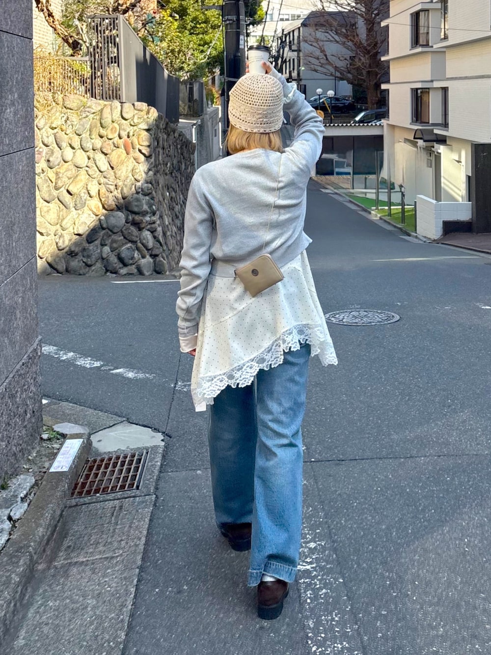 グレー系のニット/セーター、ホワイト系のワンピース、ホワイト系のニットキャップ/ビーニーを着用したレディースの春コーディネートの2枚目の写真