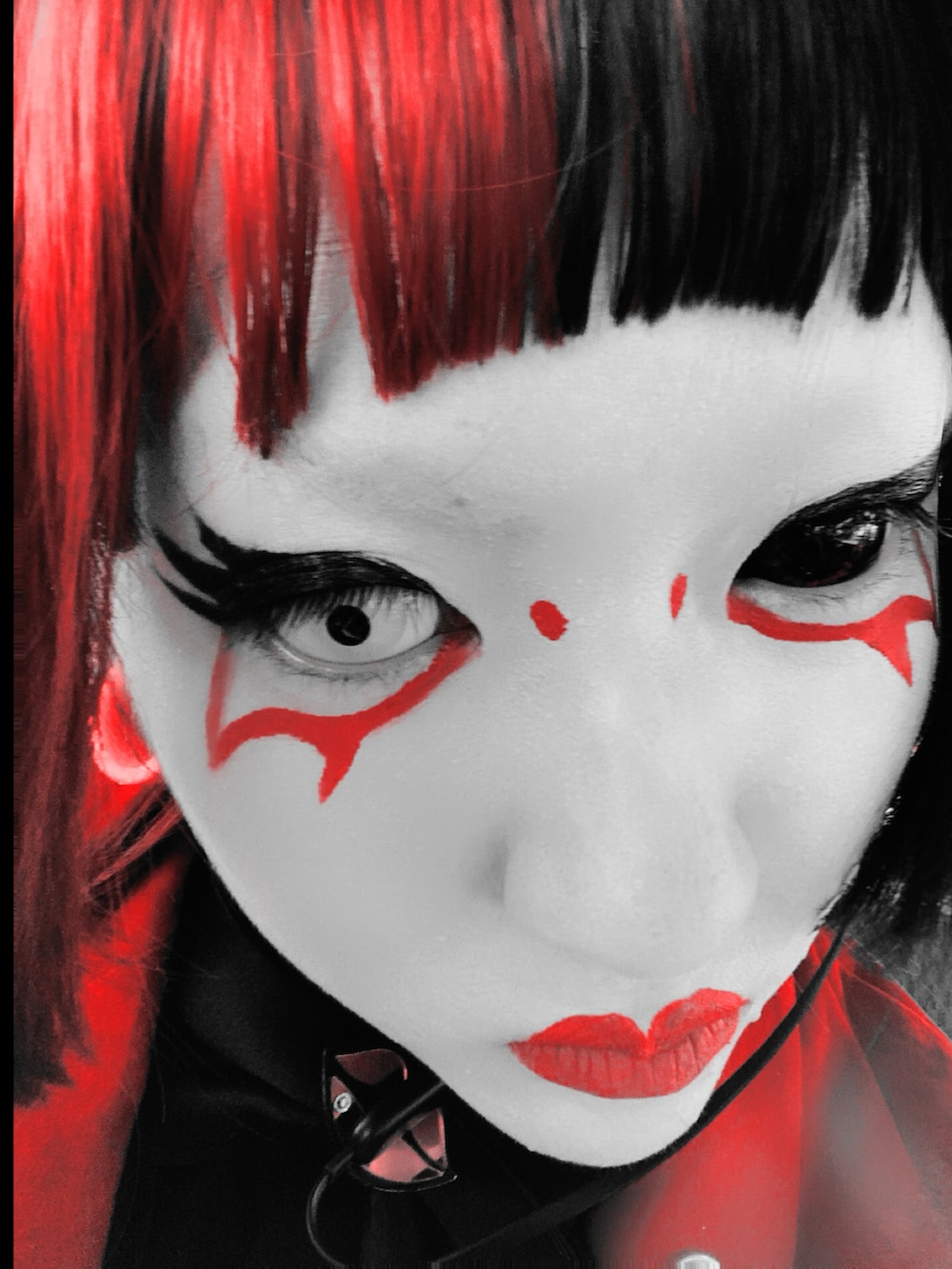 レッド系のスーツジャケット、ブラック系のニット/セーター、ブラック系のパンツを着用したレディースの冬コーディネートの2枚目の写真