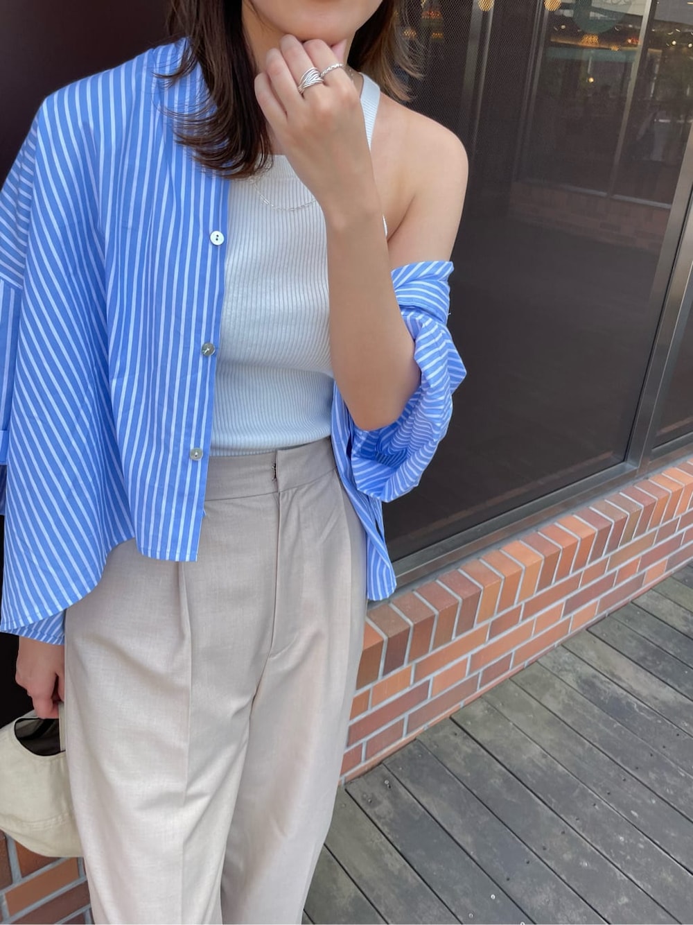 ベージュ系のその他パンツ、ブルー系のシャツ/ブラウス、ホワイト系のタンクトップを着用したレディースの春コーディネートの7枚目の写真