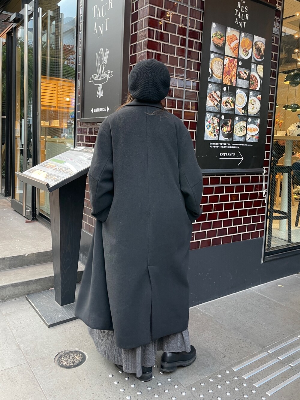 ブラック系のチェスターコート、グレー系のスウェット、グレー系のスカートを着用したレディースの秋コーディネートの6枚目の写真