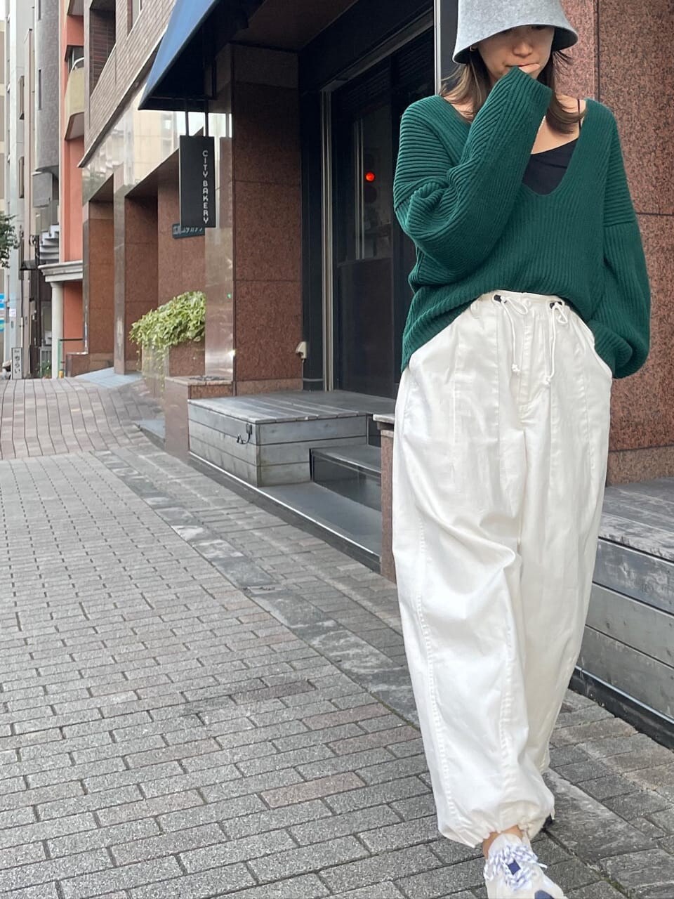 ホワイト系のその他パンツ、グリーン系のニット/セーター、グレー系のハットを着用したレディースの秋コーディネートの4枚目の写真