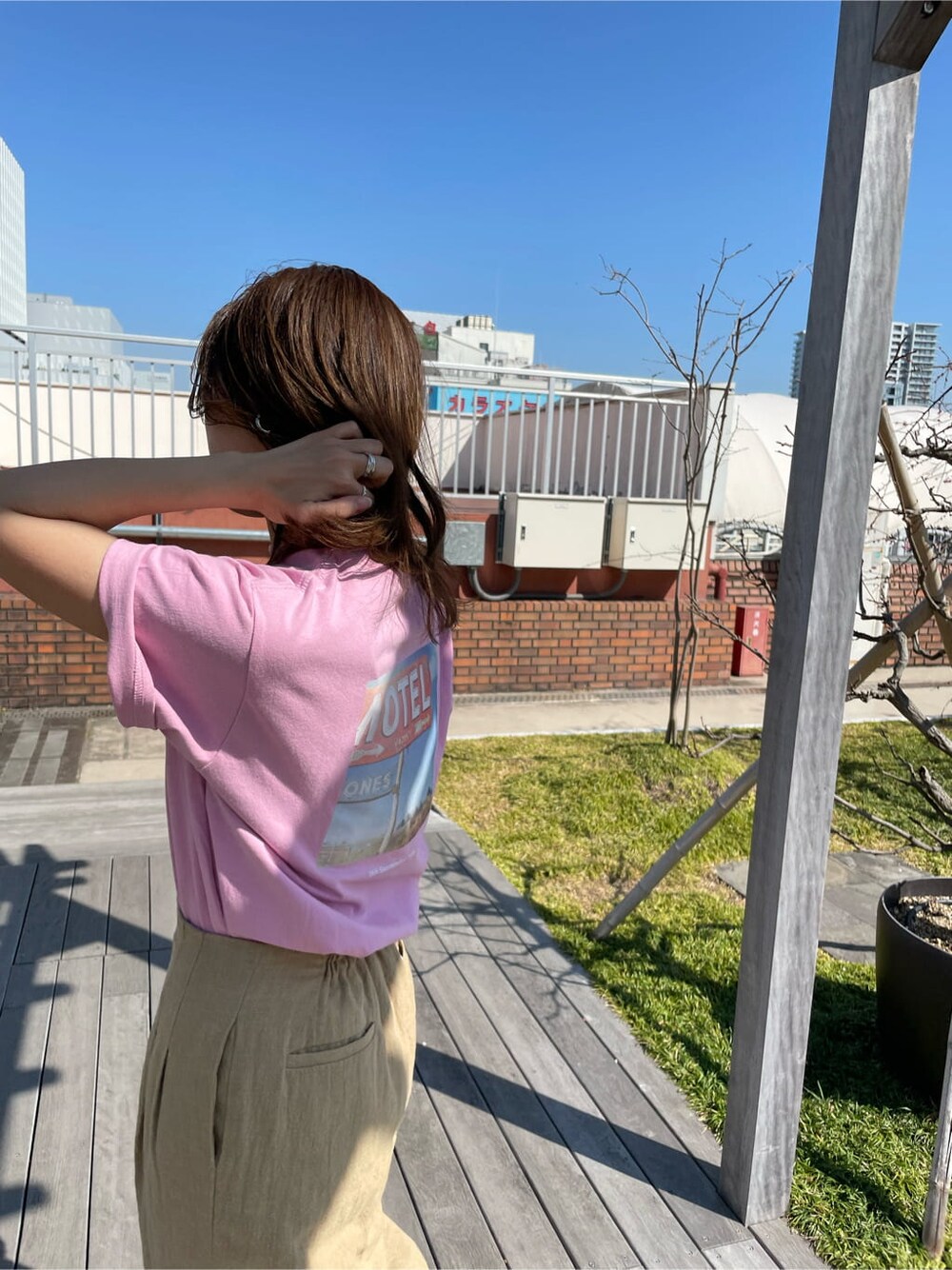 ベージュ系のその他パンツ、ピンク系のTシャツ/カットソー、ホワイト系のサンダルを着用したレディースの春コーディネートの5枚目の写真