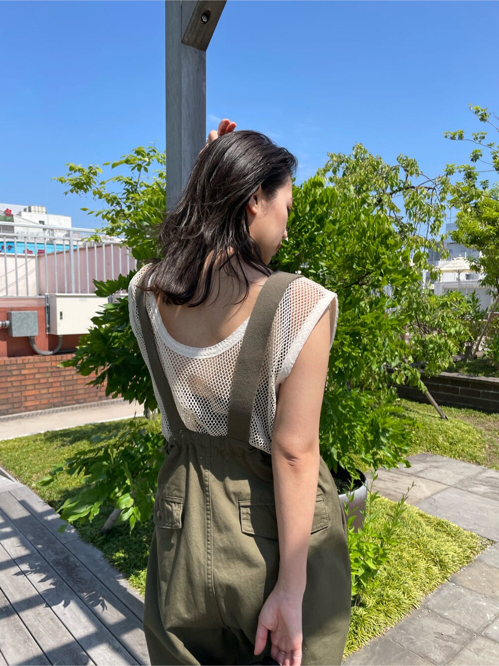 ベージュ系のサロペット/オーバーオール、ブラック系のサンダル、ブラック系のハンドバッグを着用したレディースの春コーディネートの9枚目の写真