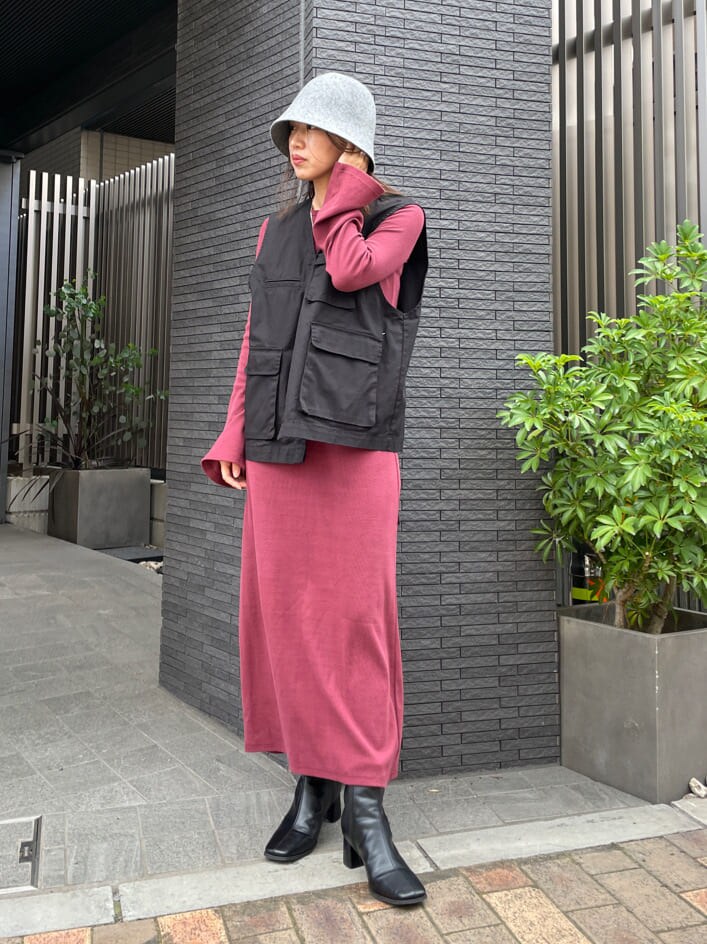 ブラック系のブルゾン、レッド系のワンピース、ブラック系のブーツを着用したレディースの夏コーディネートの10枚目の写真