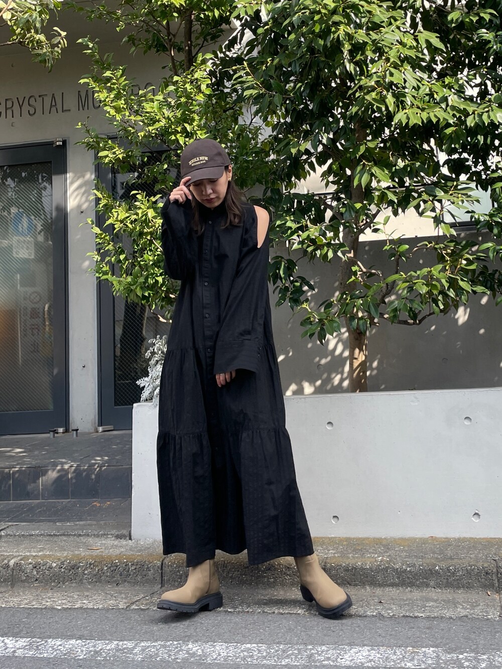 ブラック系のワンピース、ベージュ系のブーツ、グレー系のキャップを着用したレディースの冬コーディネートの5枚目の写真