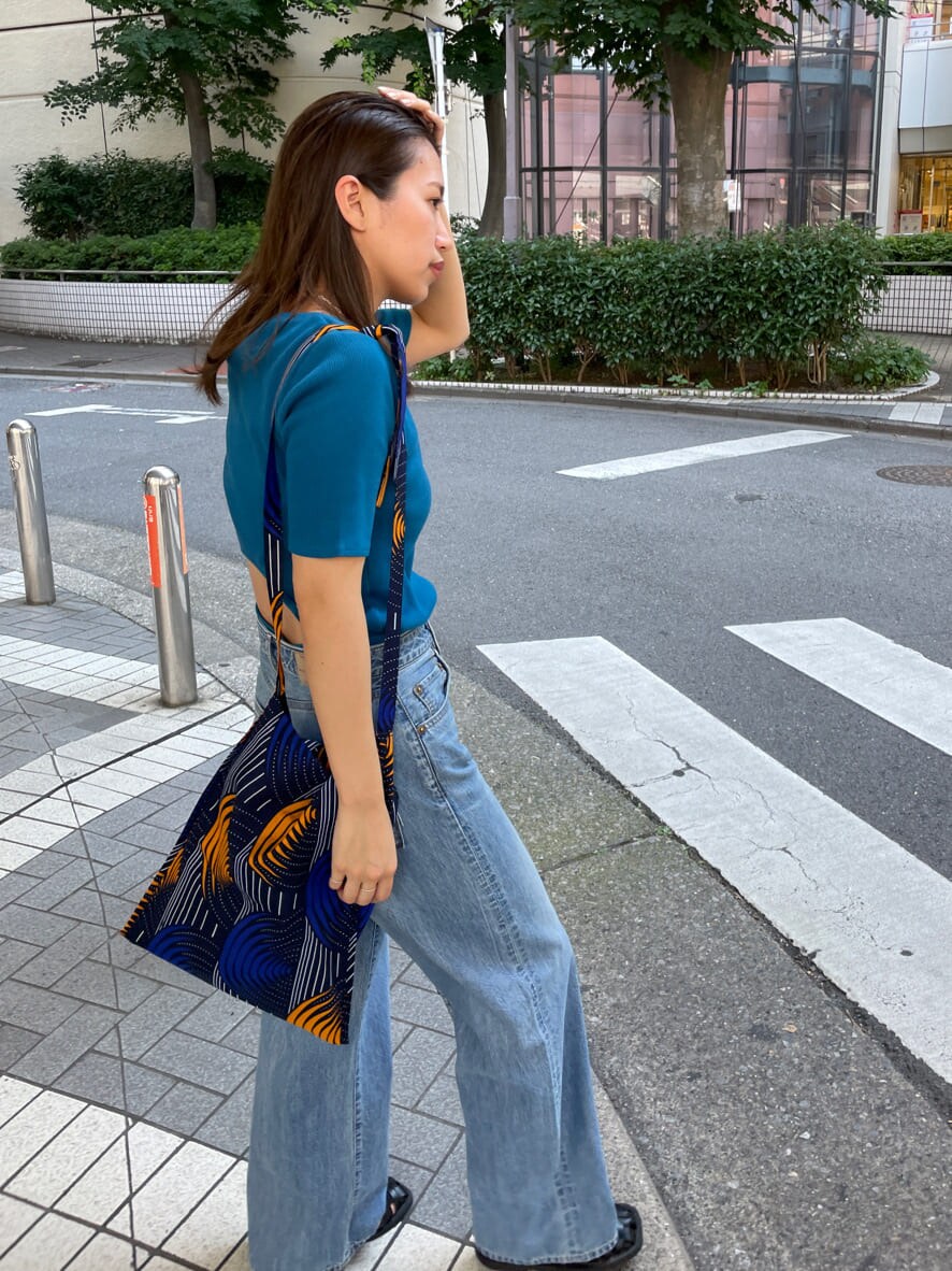 ブルー系のショルダーバッグ、ブルー系のTシャツ/カットソー、ブルー系のデニムパンツを着用したレディースの夏コーディネートの4枚目の写真