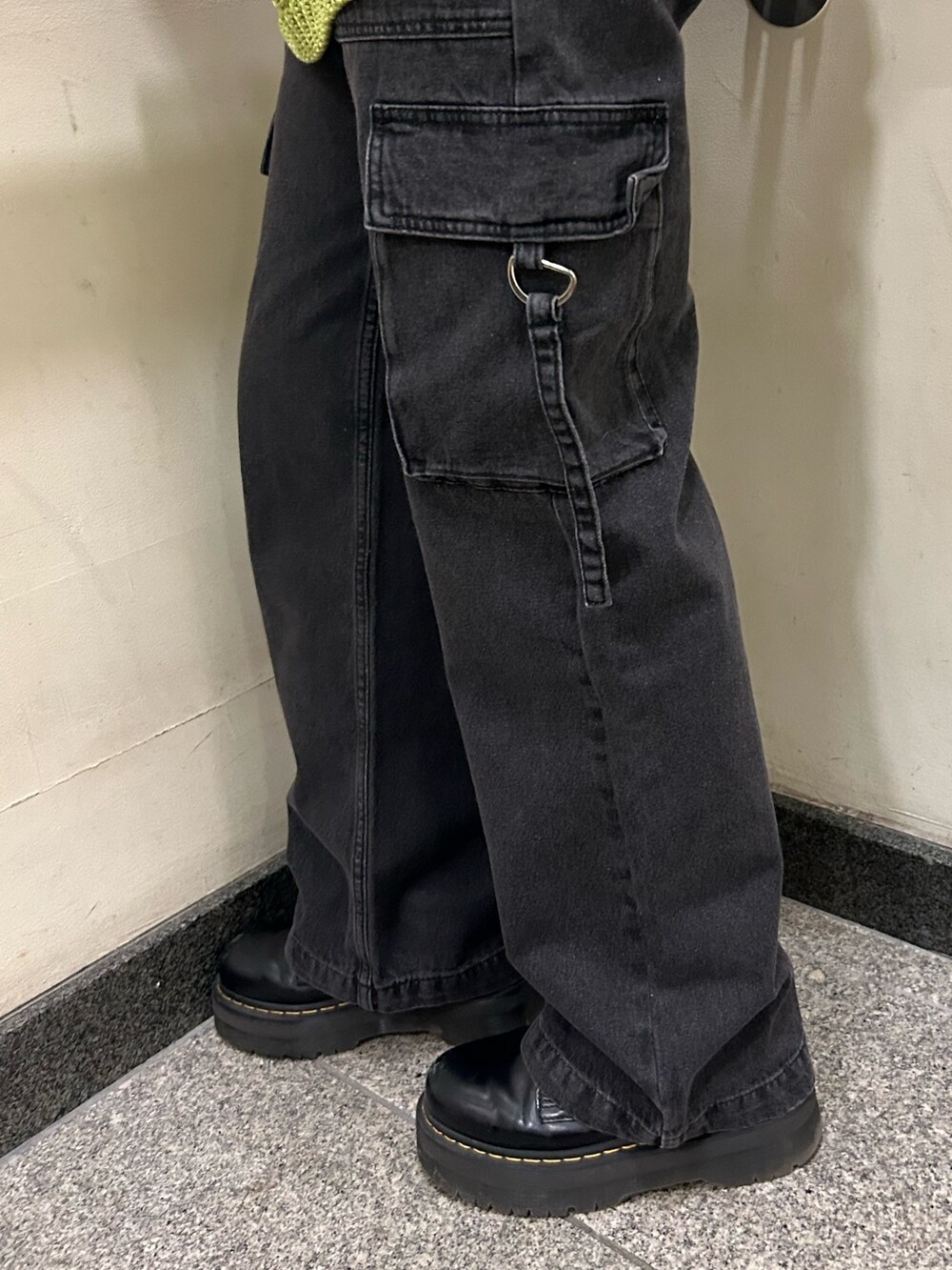 ホワイト系のTシャツ/カットソー、ブラック系のカーゴパンツ、グリーン系のベストを着用したレディースの春コーディネートの6枚目の写真