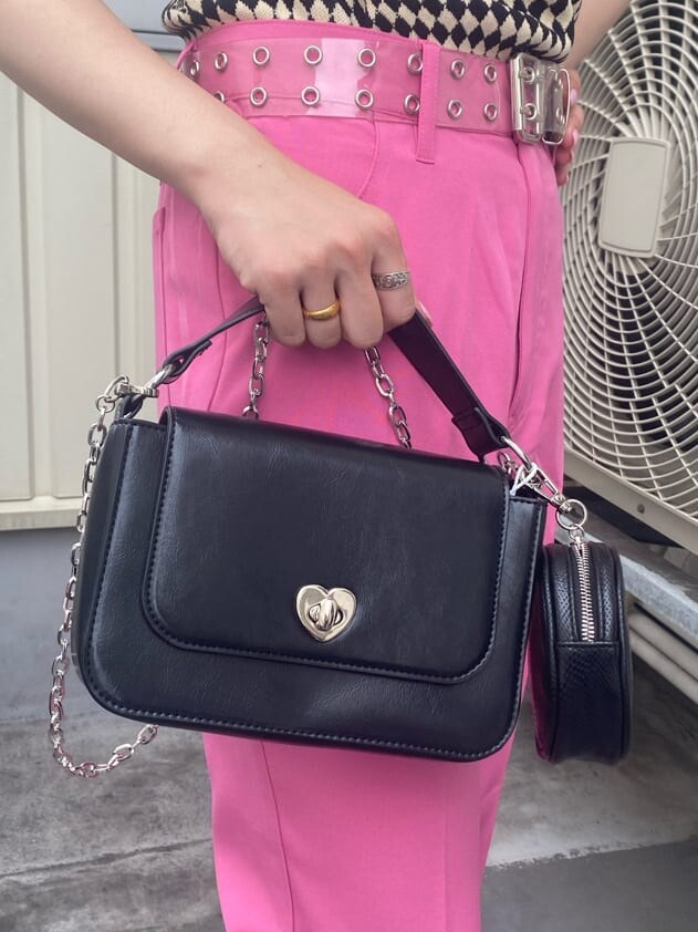 ブラック系のニット/セーター、ホワイト系のTシャツ/カットソー、ピンク系のスラックスを着用したレディースの夏コーディネートの9枚目の写真