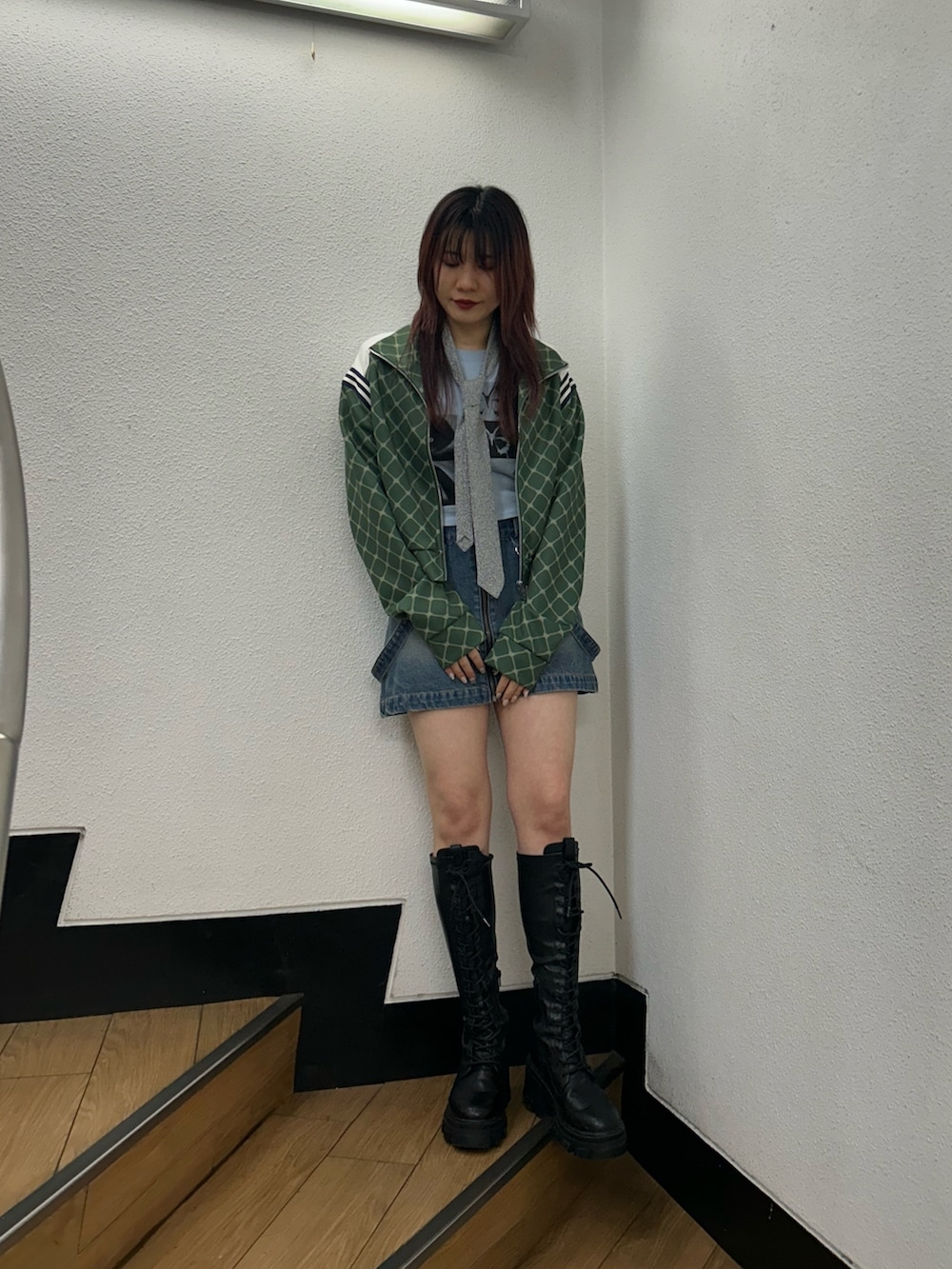 グリーン系のジャージ、ブルー系のデニムスカート、ブルー系のTシャツ/カットソーを着用したレディースの春コーディネートの2枚目の写真