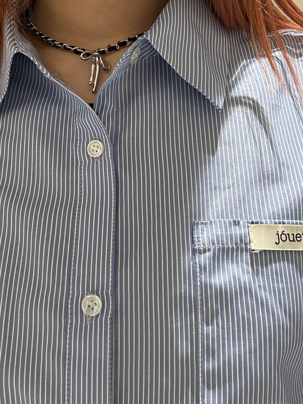 ブルー系のシャツ/ブラウス、ブラック系のデニムパンツ、ブラック系のブーツを着用したレディースの冬コーディネートの6枚目の写真