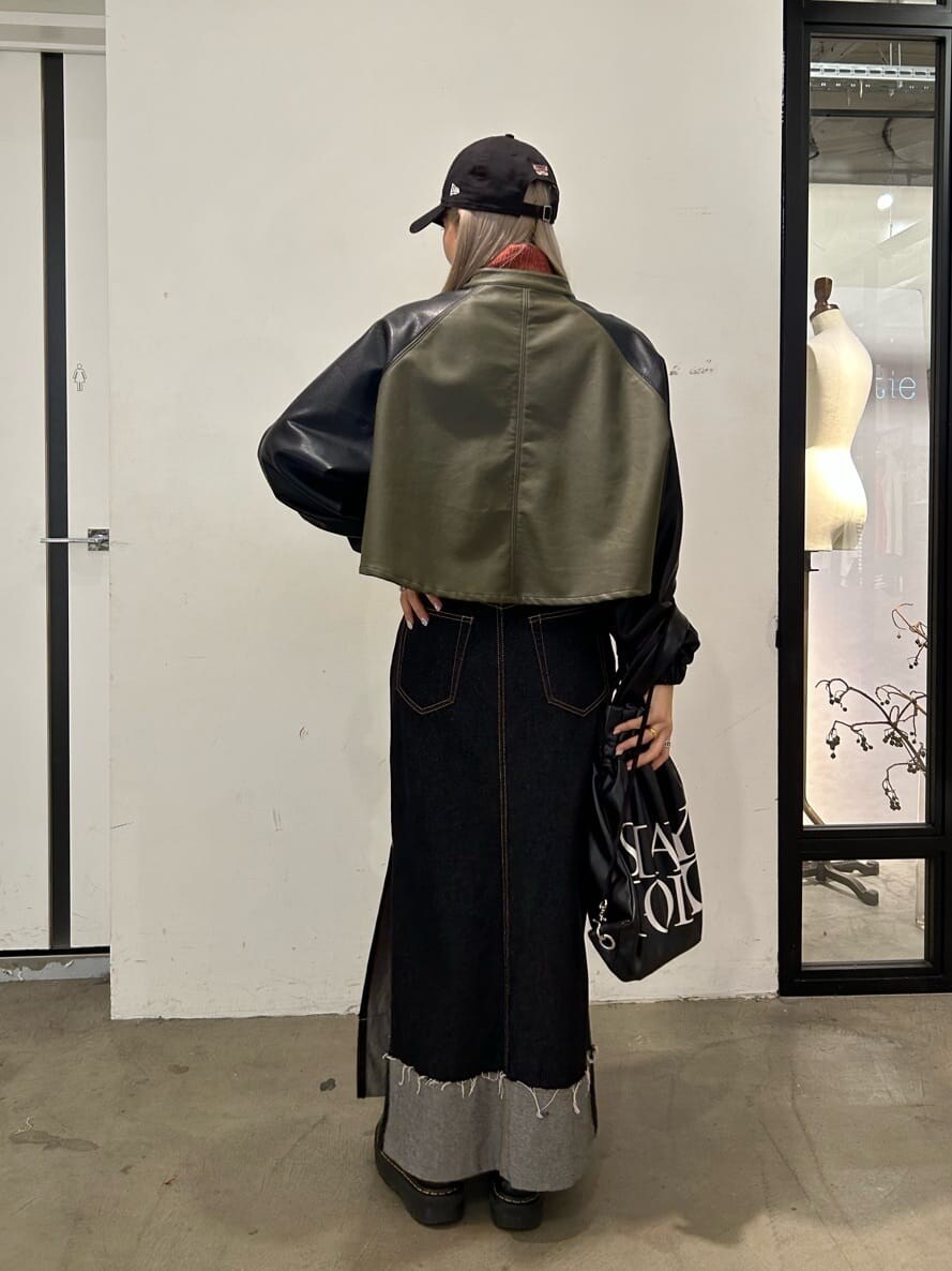 ブラック系のデニムスカート、ブラック系のその他シューズ、ブラック系のバックパック/リュックを着用したレディースの秋コーディネートの3枚目の写真