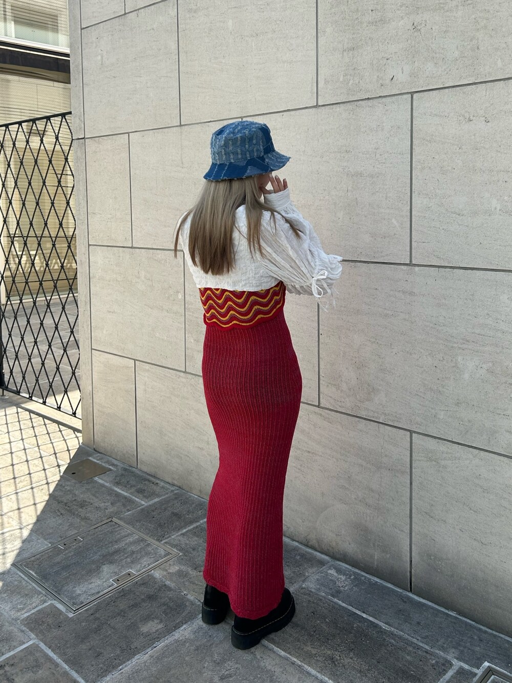 ブラック系のその他シューズ、ホワイト系のカーディガン/ボレロ、シルバー系のネックレスを着用したレディースの春コーディネートの2枚目の写真