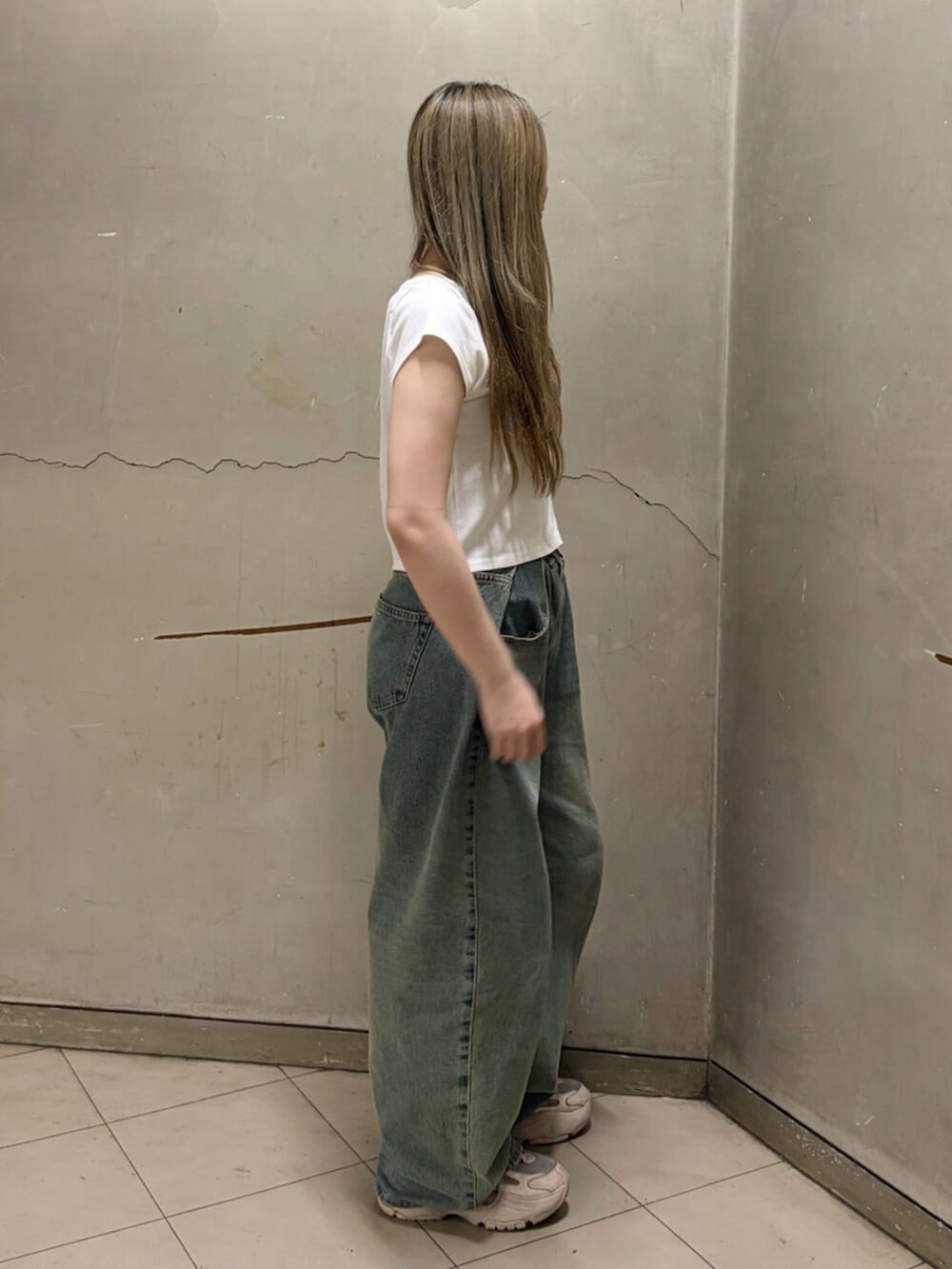 ブルー系のデニムパンツ、ホワイト系のTシャツ/カットソーを着用したレディースの春コーディネートの3枚目の写真