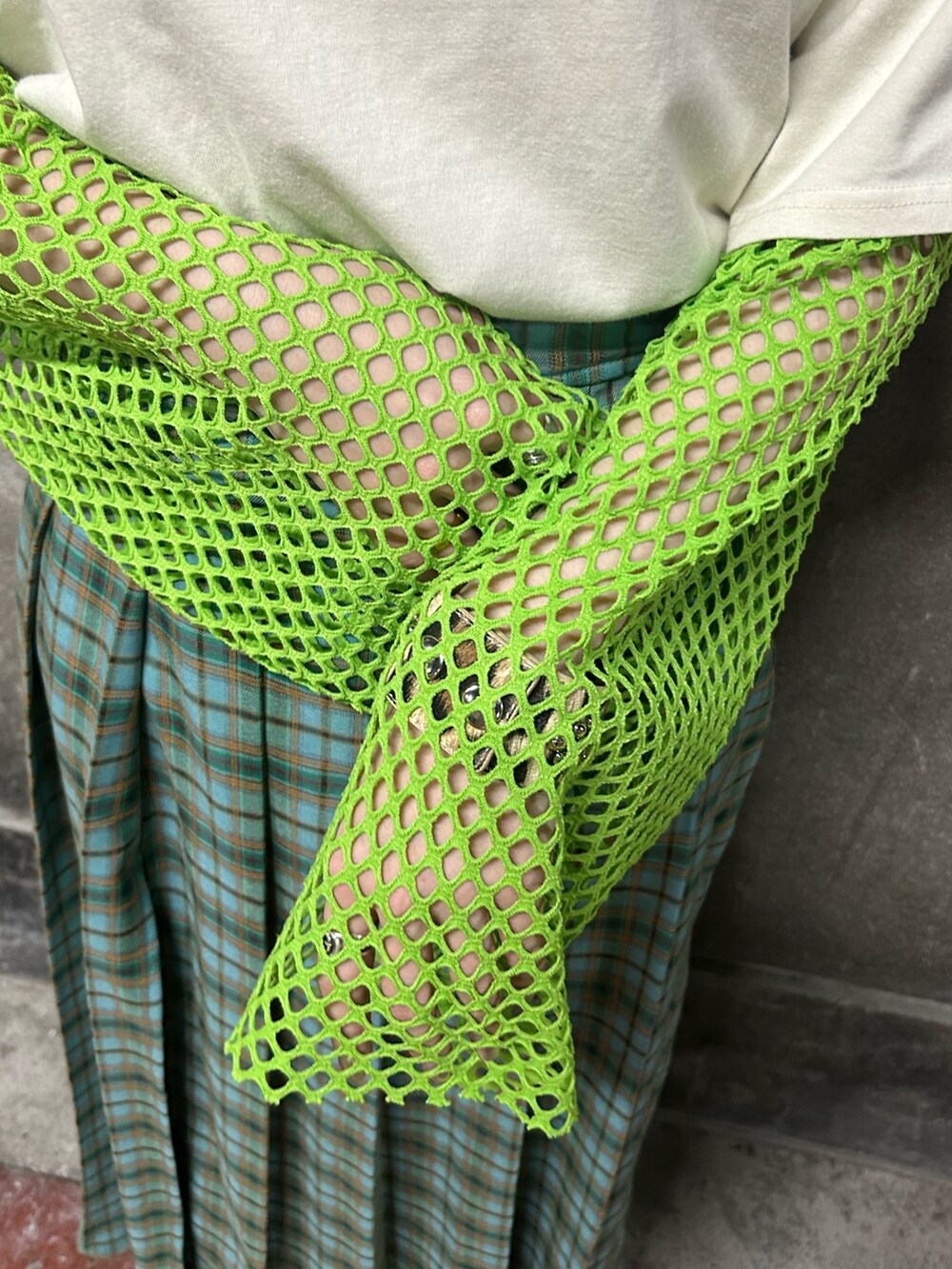 グリーン系のTシャツ/カットソー、グリーン系のスカート、ホワイト系のTシャツ/カットソーを着用したレディースの春コーディネートの5枚目の写真