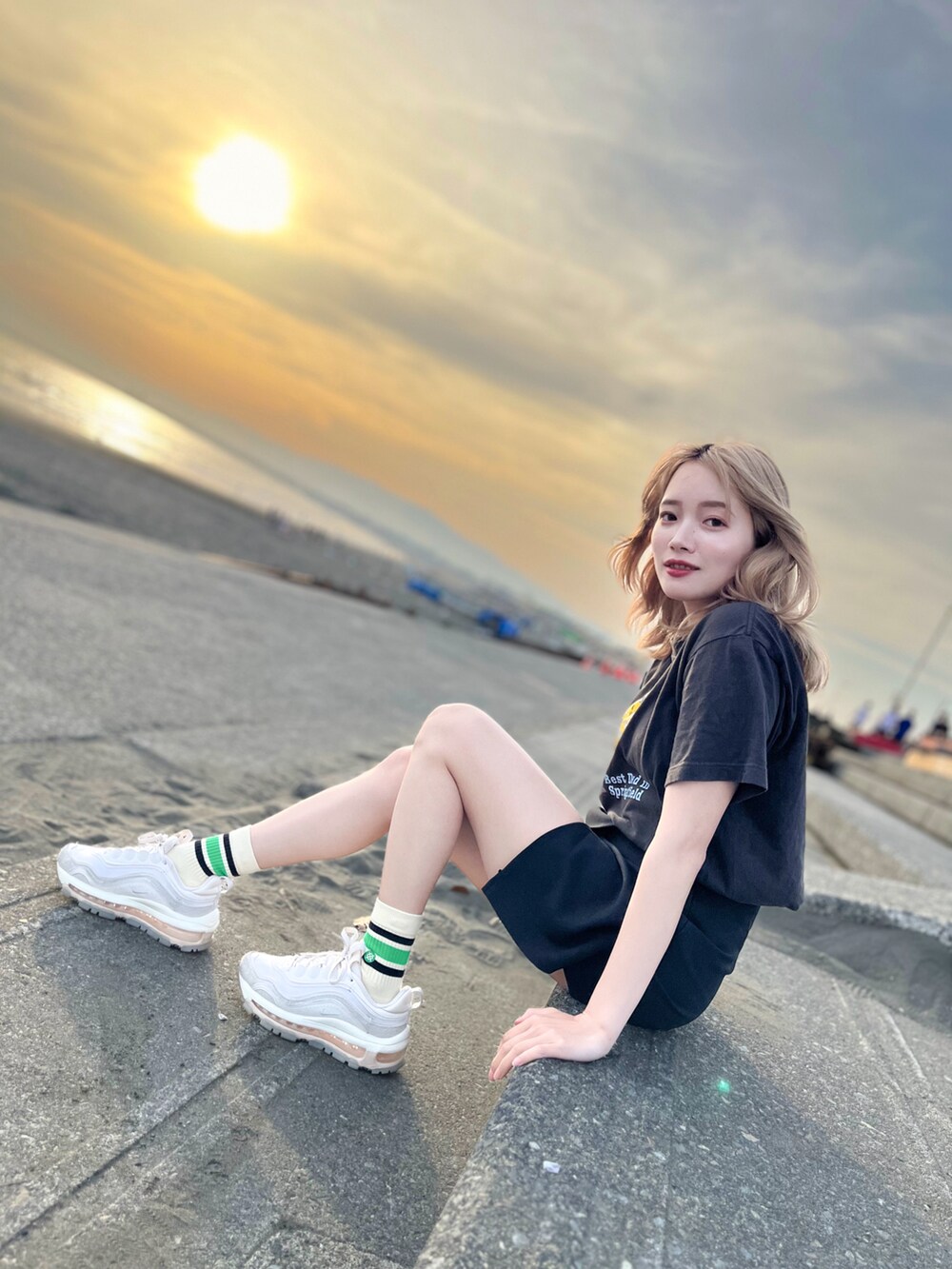 ブラック系のその他パンツ、ブラック系のTシャツ/カットソー、ホワイト系のスニーカーを着用したレディースの春コーディネートの2枚目の写真